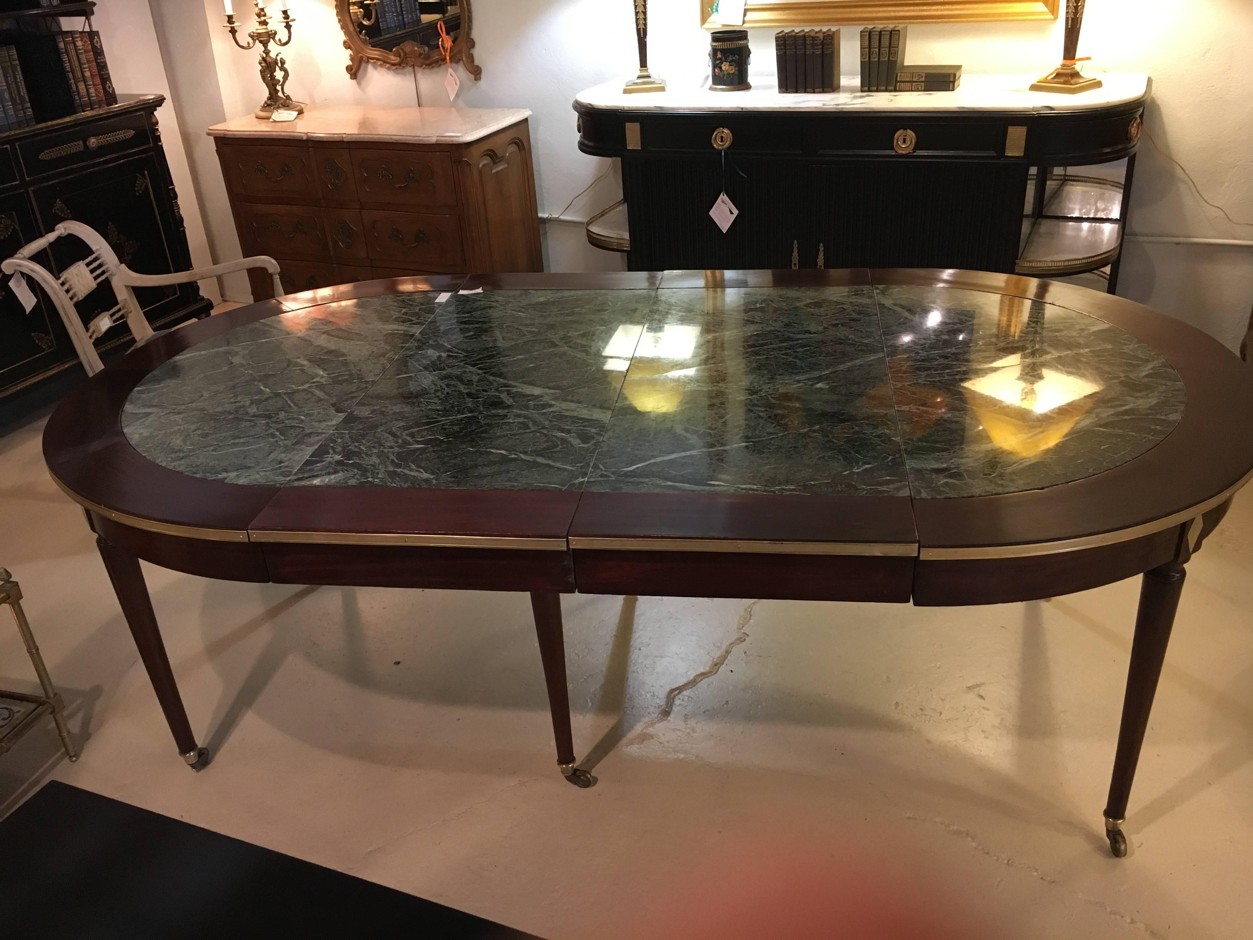 An earlier piece by this iconic designer. Maison Jansen circular dining table with two 20