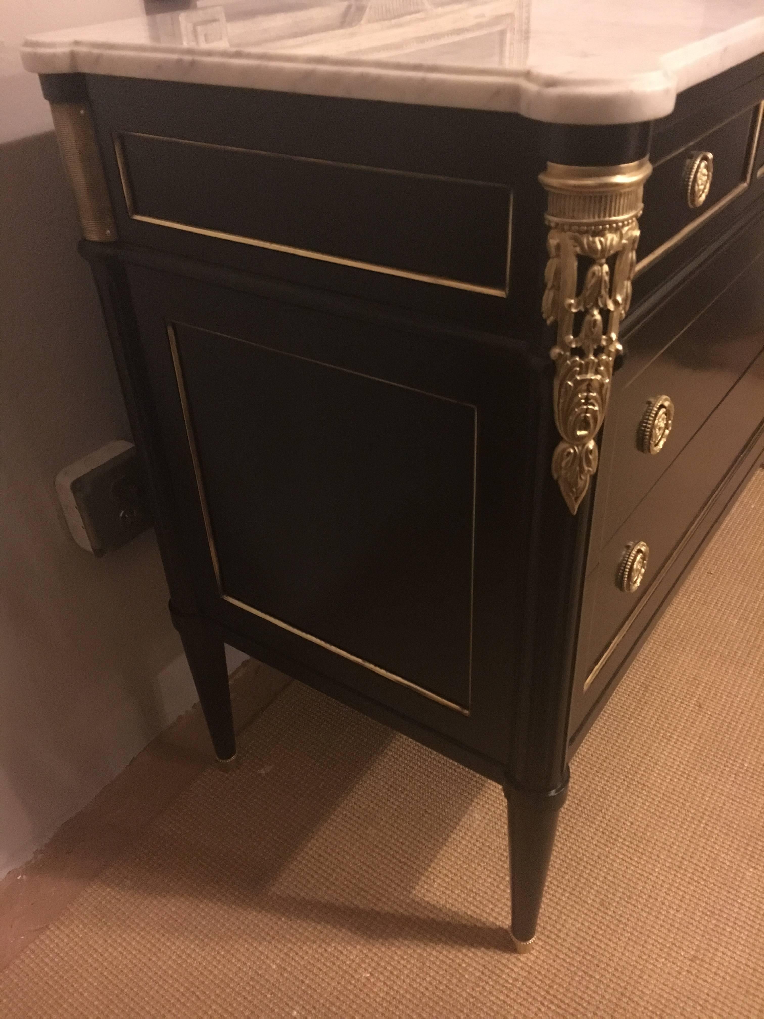 Maison Jansen Louis XVI style bronze-mounted marble-top three drawer commode. This finely constructed commode has been recently redone and cleaned to show the wonderful detail on the bonze mounts. The case supporting a white marble-top.