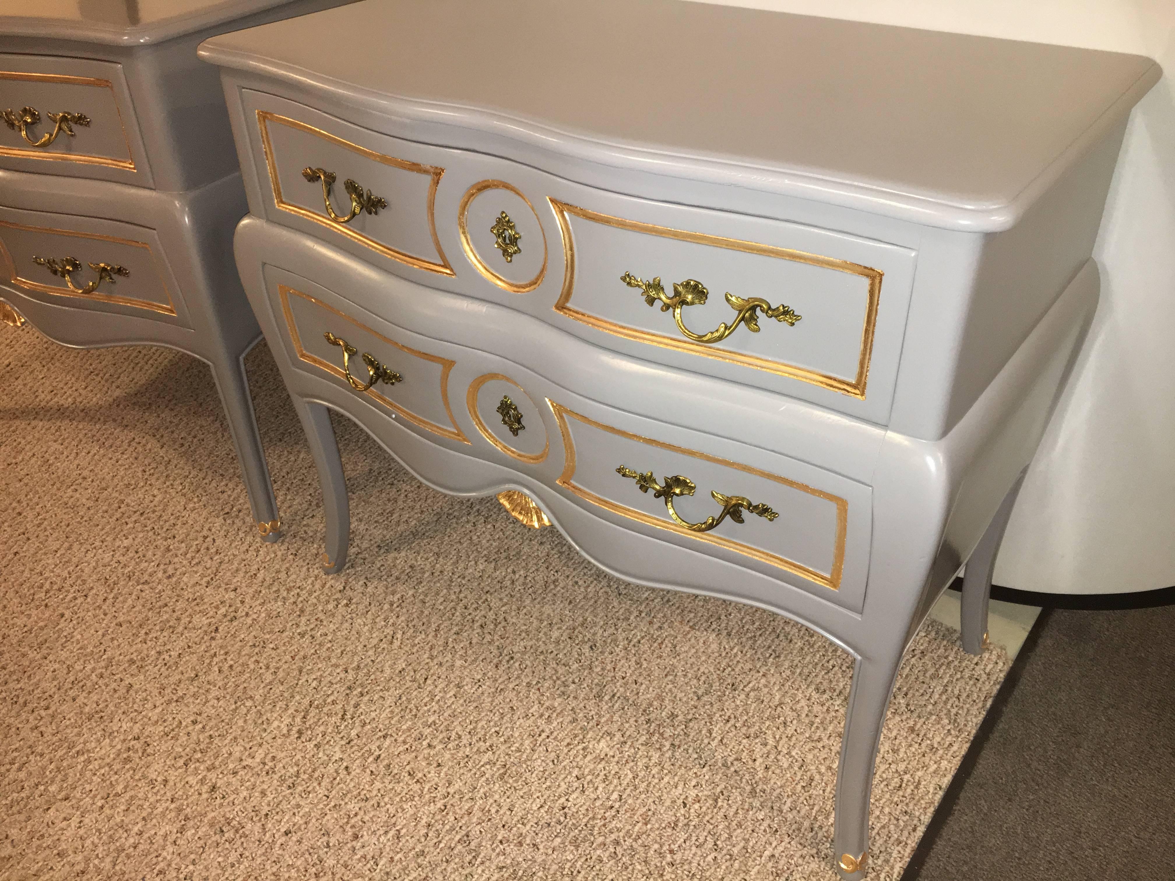 Pair of Louis XV style paint and gilt decorated commodes nightstands. These finely painted chests appear to be either by John Stuart or John Widdercomb. The double serpentine fronts having bronze pulls on two drawers. Each case painted in a slate