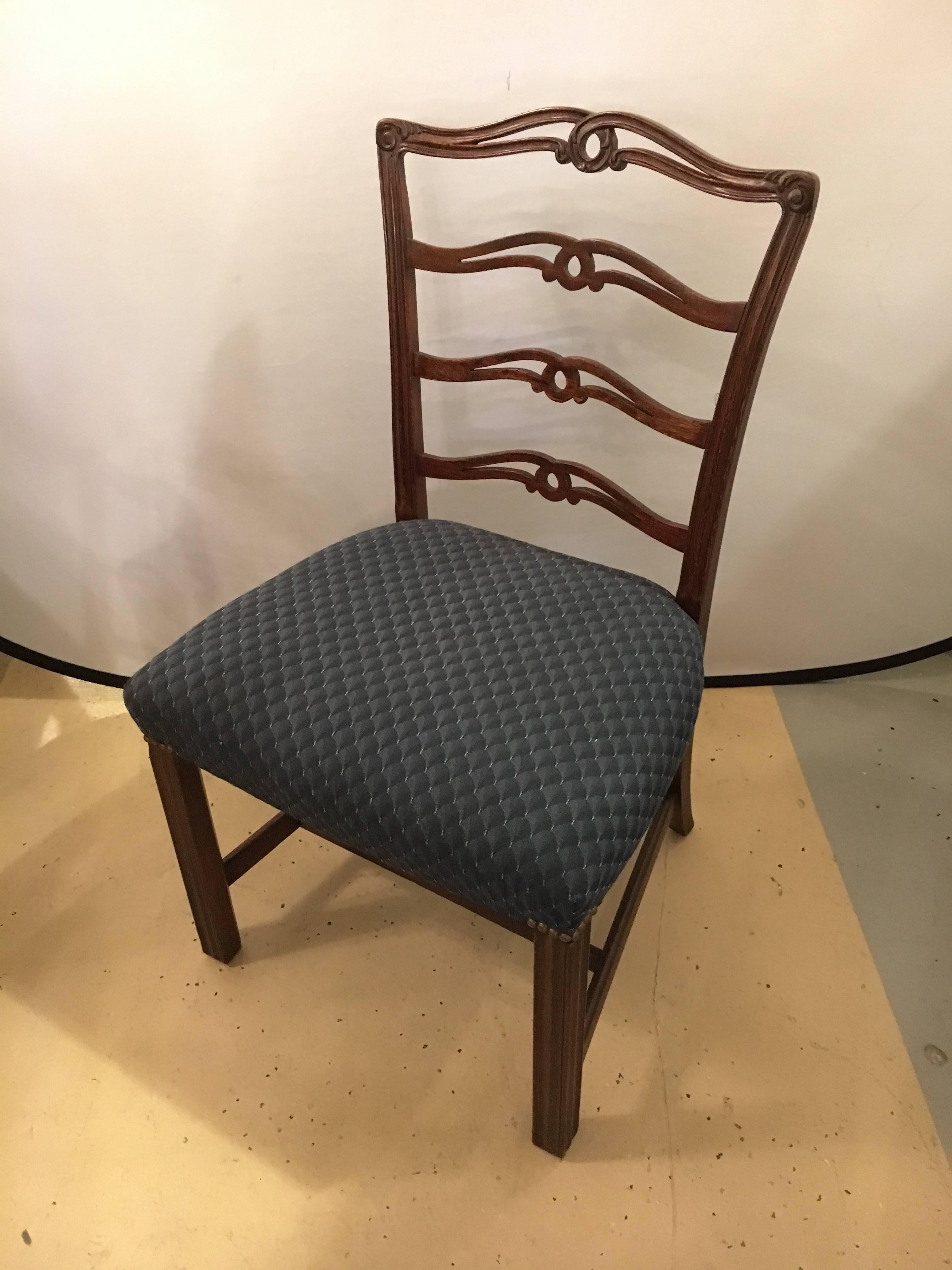 Pair 1930s mahogany ladder back dining side chairs.  Each with square legs and crossbar bottoms in the Georgian style. All having pretzel ladder backs. A fine pair of dining chairs.


Measurements for side chairs: 36 H x 22 W x 19 D
