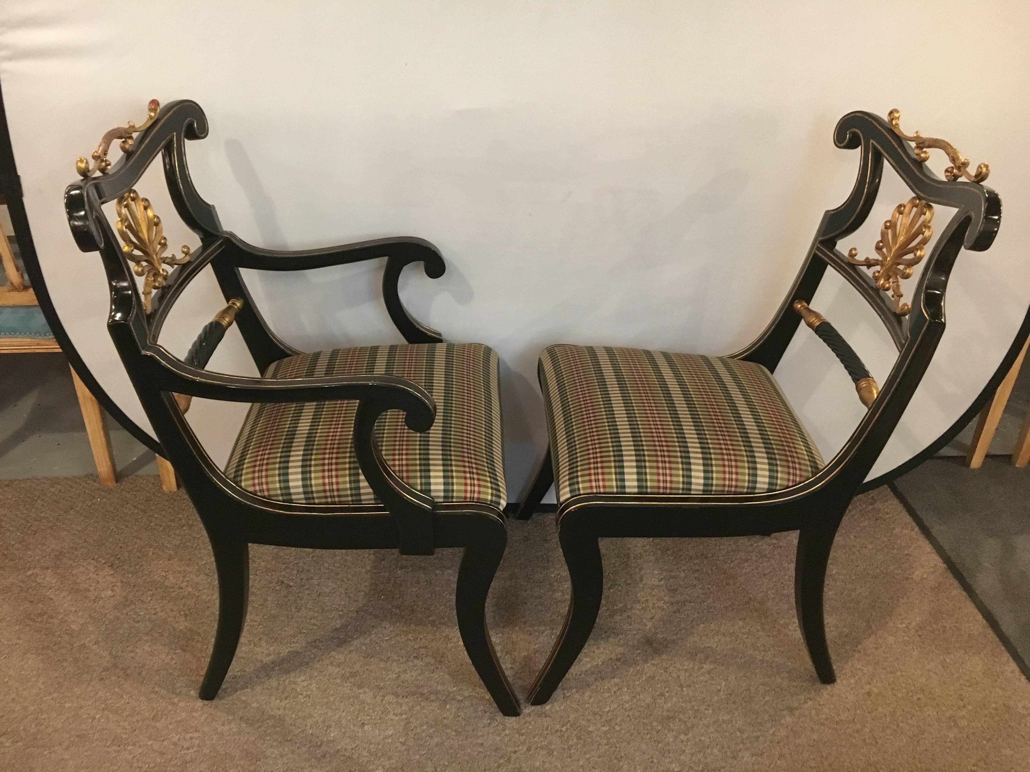 Set of six neoclassical style ebonized and brass-mounted dining chairs. Pair of armchairs and four side chairs of custom quality make up this unique set. Each having gilt metal back splats and metal handles on top rail. This fine ebonized set of