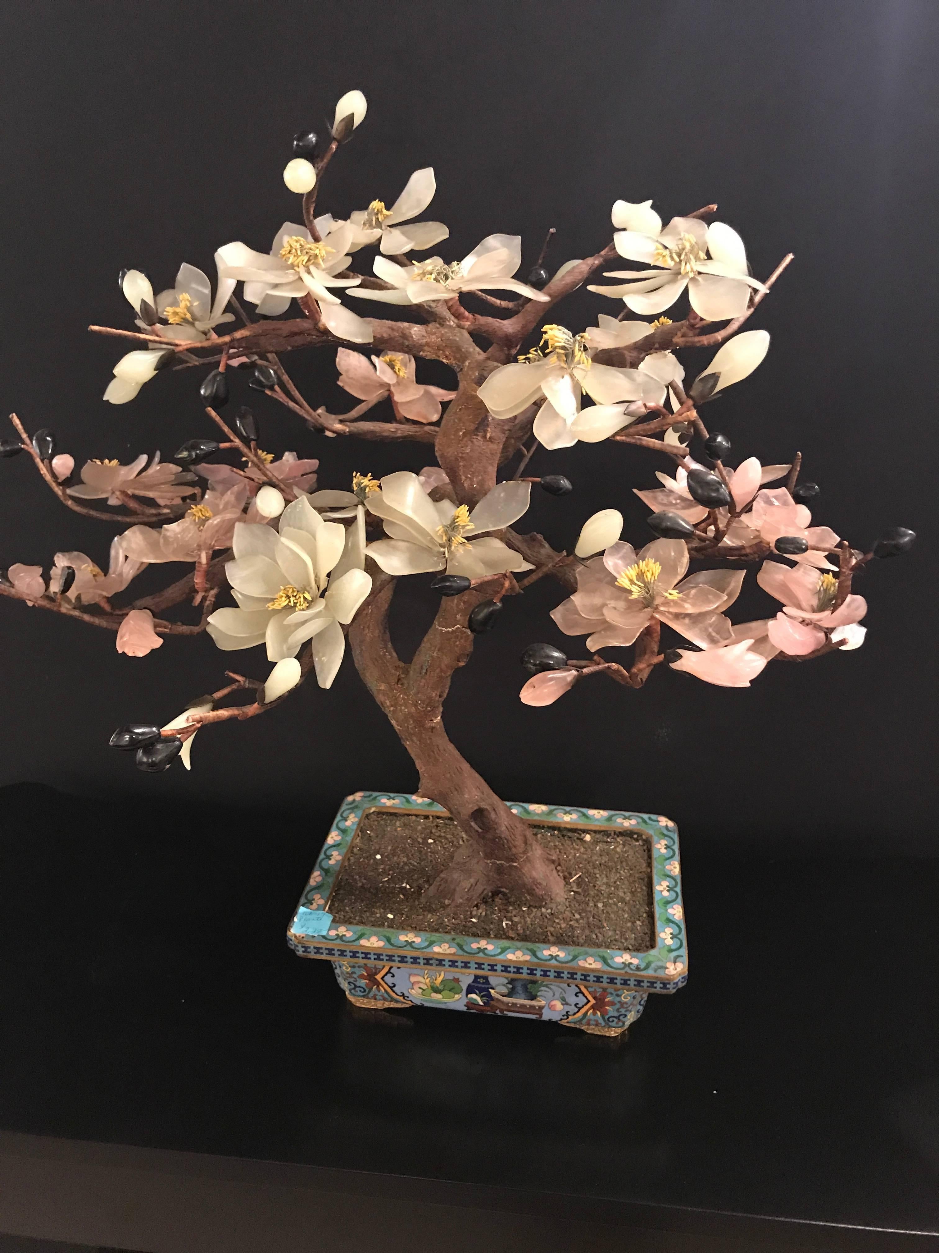 One large Chinese hardstone tree in chinoiserie planter. Chinese flowering various multicolored hardstones tree and cloisonné enameled pot; rectangular form pot with floral and fruit designs.