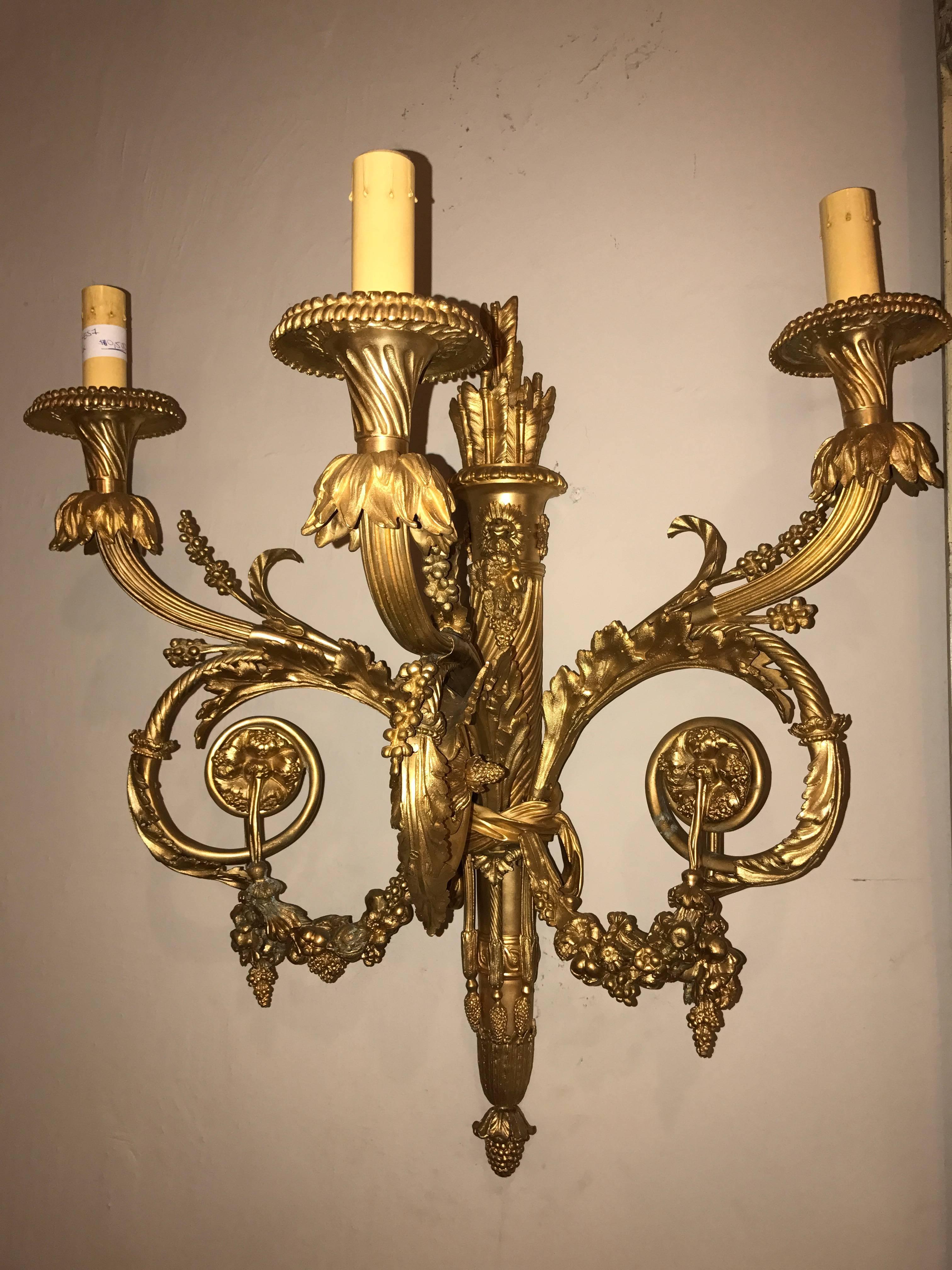 A pair of monumental three-light sconces solid bronze Louis XVI style. At the time of this listing I have three pair available. Price is for one pair only.