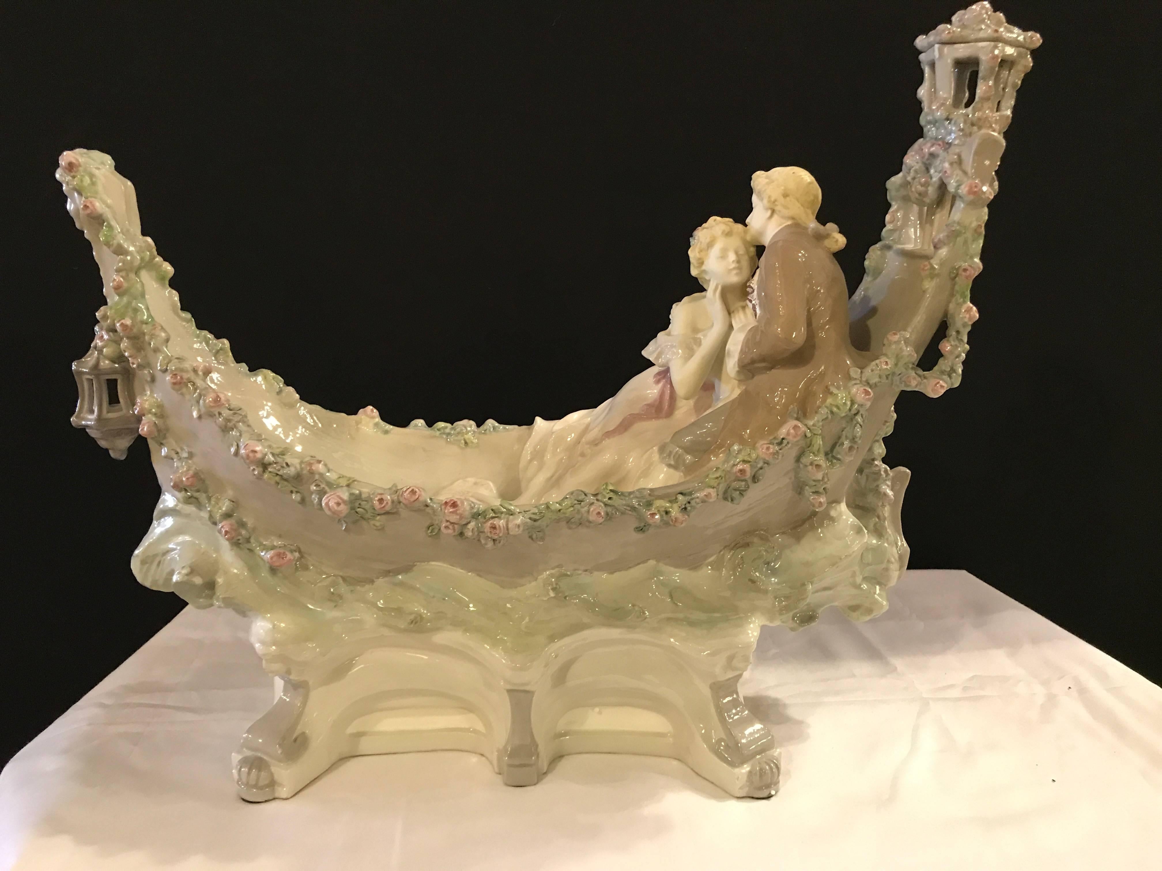 Unusual signed palatial gondola center piece. Made of porcelain having lovers traveling down the river this very colorful and fine centre piece is sure to make any table it sits on simply light up.