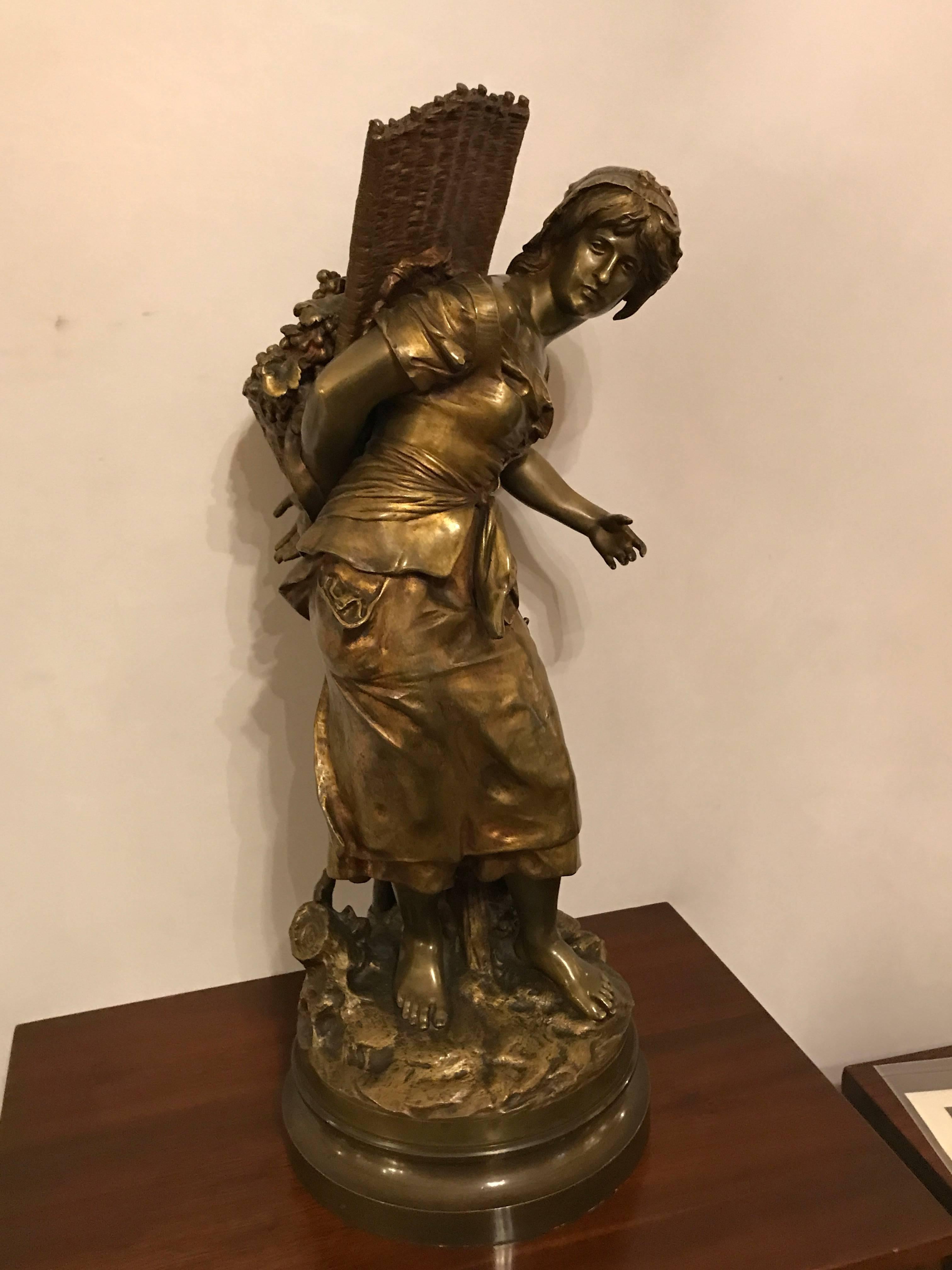 Palatial bronze sculpture of a young girl picking grapes signed Mathurin Moreau, bearing the Foundry Seal. The title of the work "The Young Grape Picker". This large and impressive bronze sits on a revolving bronze base and is finely