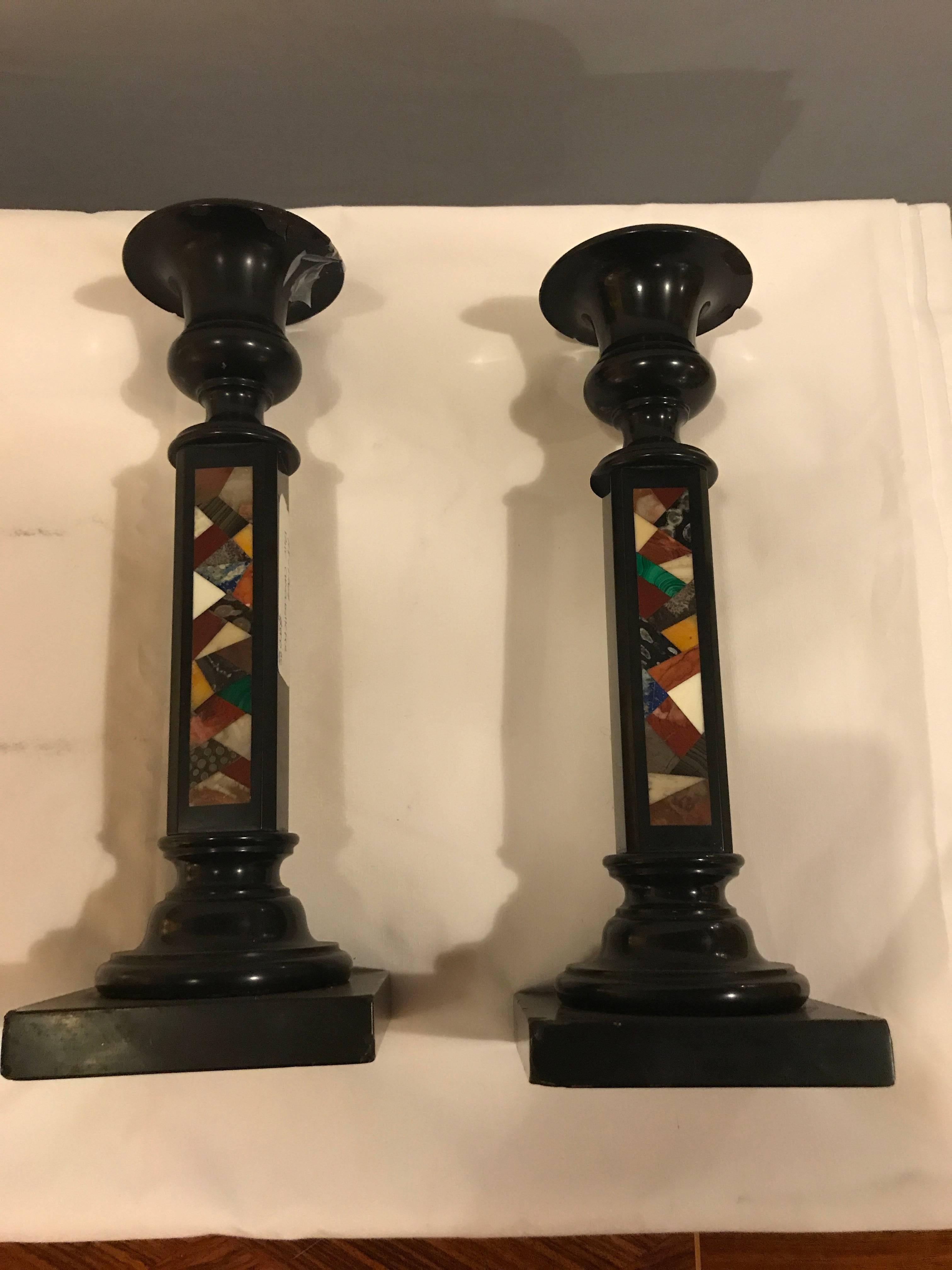 A pair of micro mosaic black candlesticks. These may have been previously repaired it is very difficult to tell.