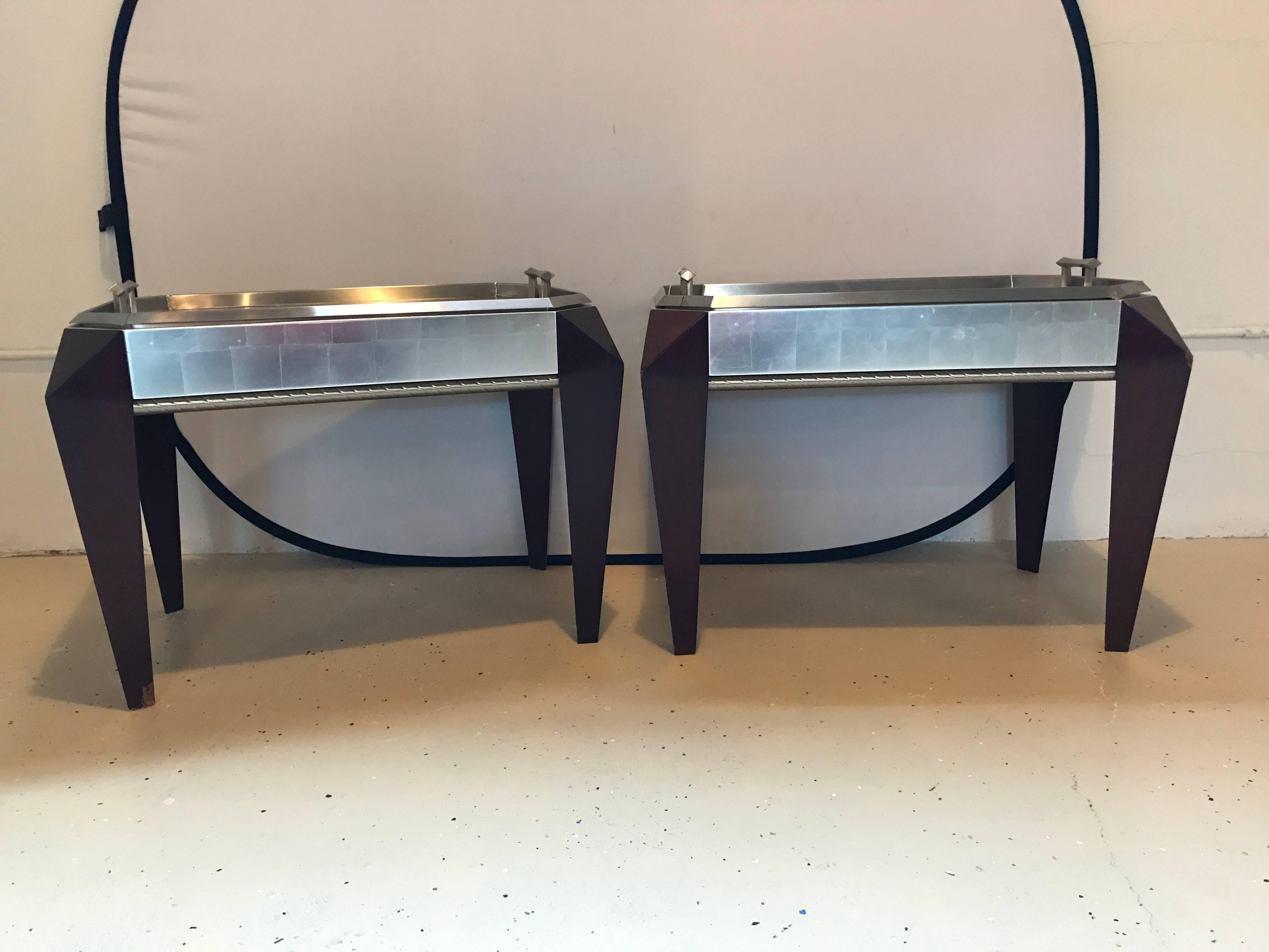 Pair of Hollywood Regency Style Dakota Jackson stainless steel serving trays on mahogany legs. These finely crafted, highly functional serving trays can sit on their mahogany bases or can easily be removed to serve. Both octagonal shaped trays have