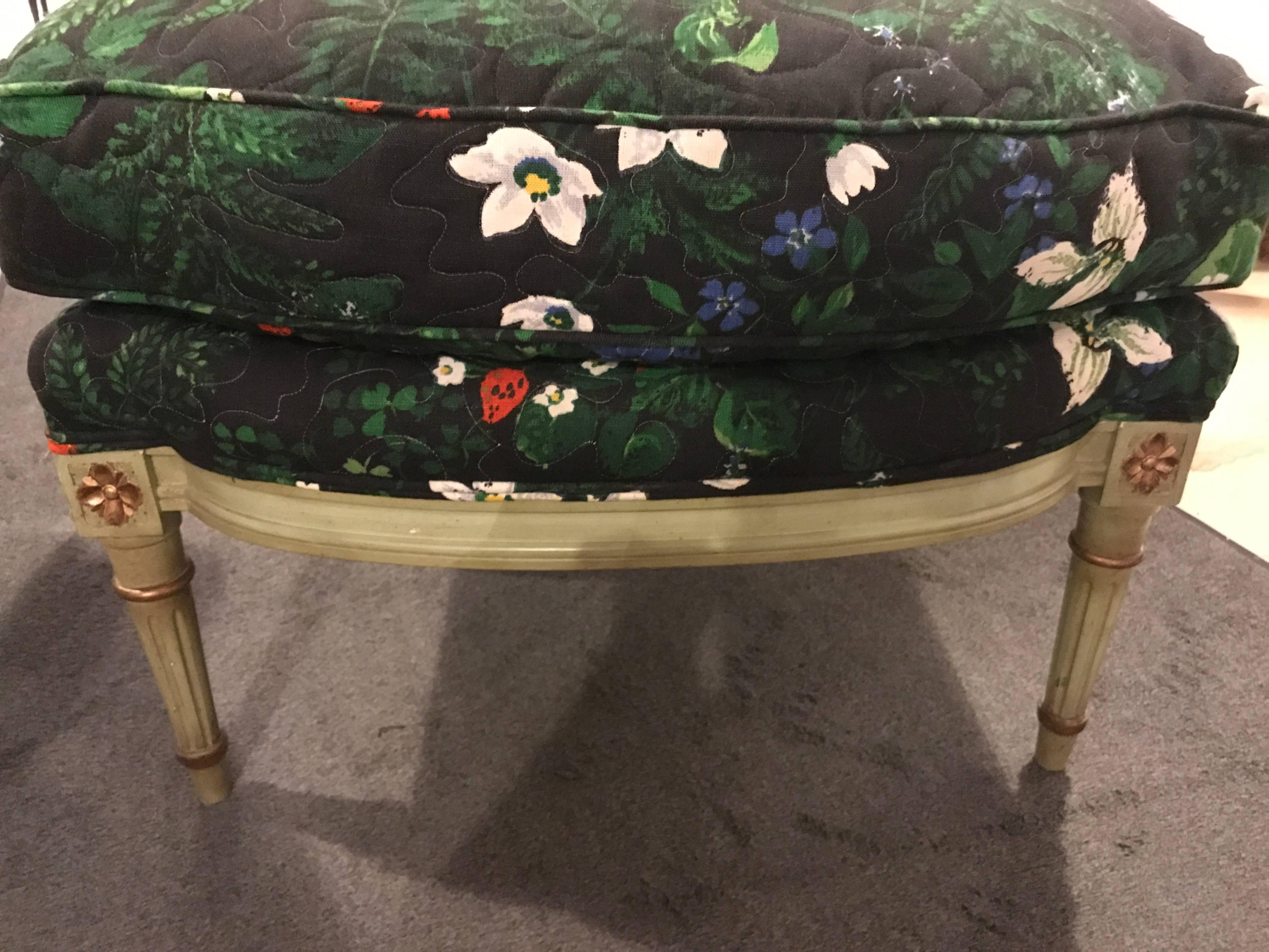 Pair of Louis XVI style Bergere chairs and matching ottomans. The greenish and gilt gold decorated frames in the Louis XVI fashion with carved rosettes on the frames and a clean floral upholstery. Can purchase only chairs or only ottoman if that is