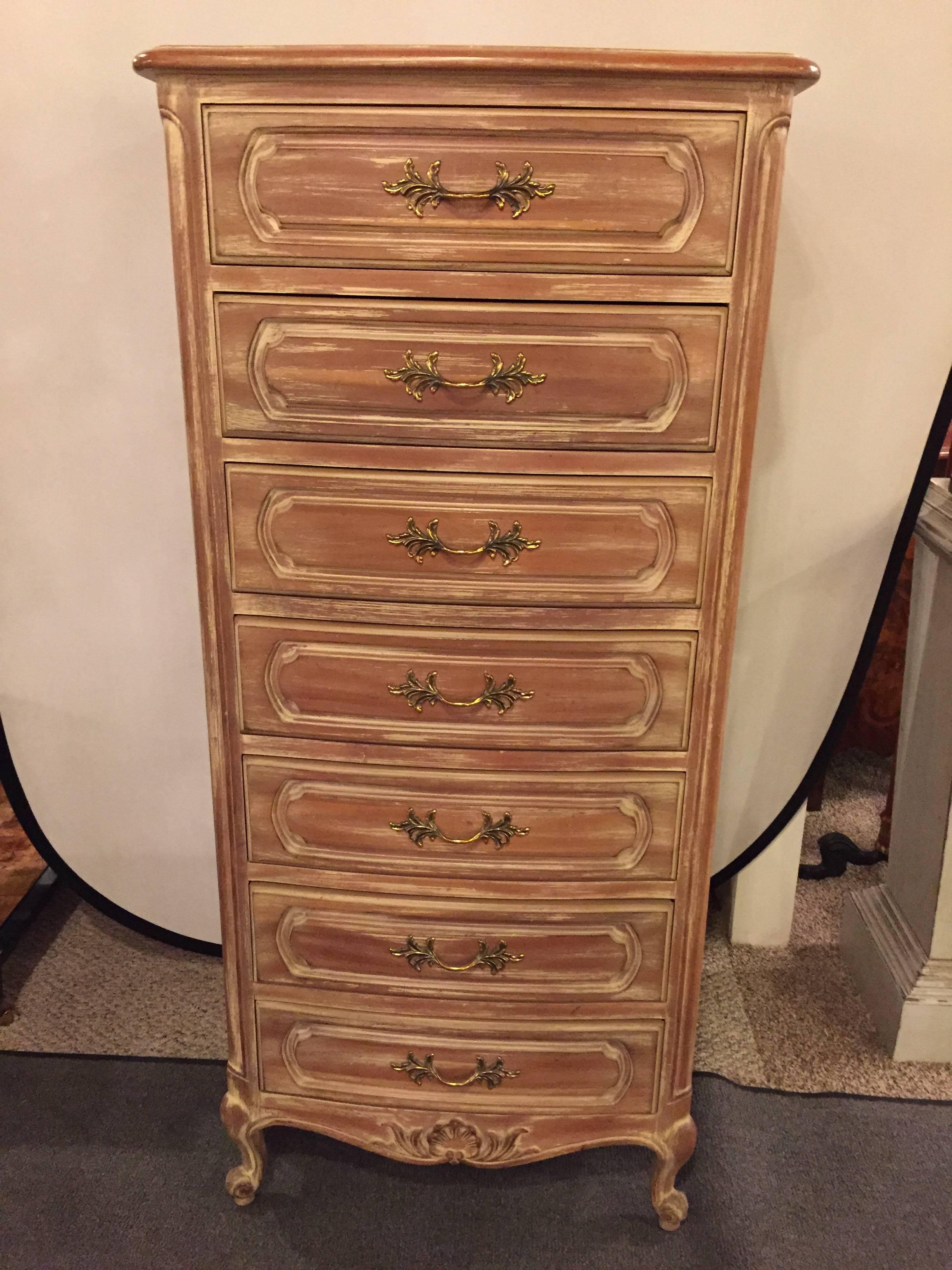 Distress painted Louis XV Style Llingerie chest. Having seven drawers with brass pulls stands this tall and sleek Hollywood Regency style lingerie chest by century. The overall chest in a distressed pickle finish.
