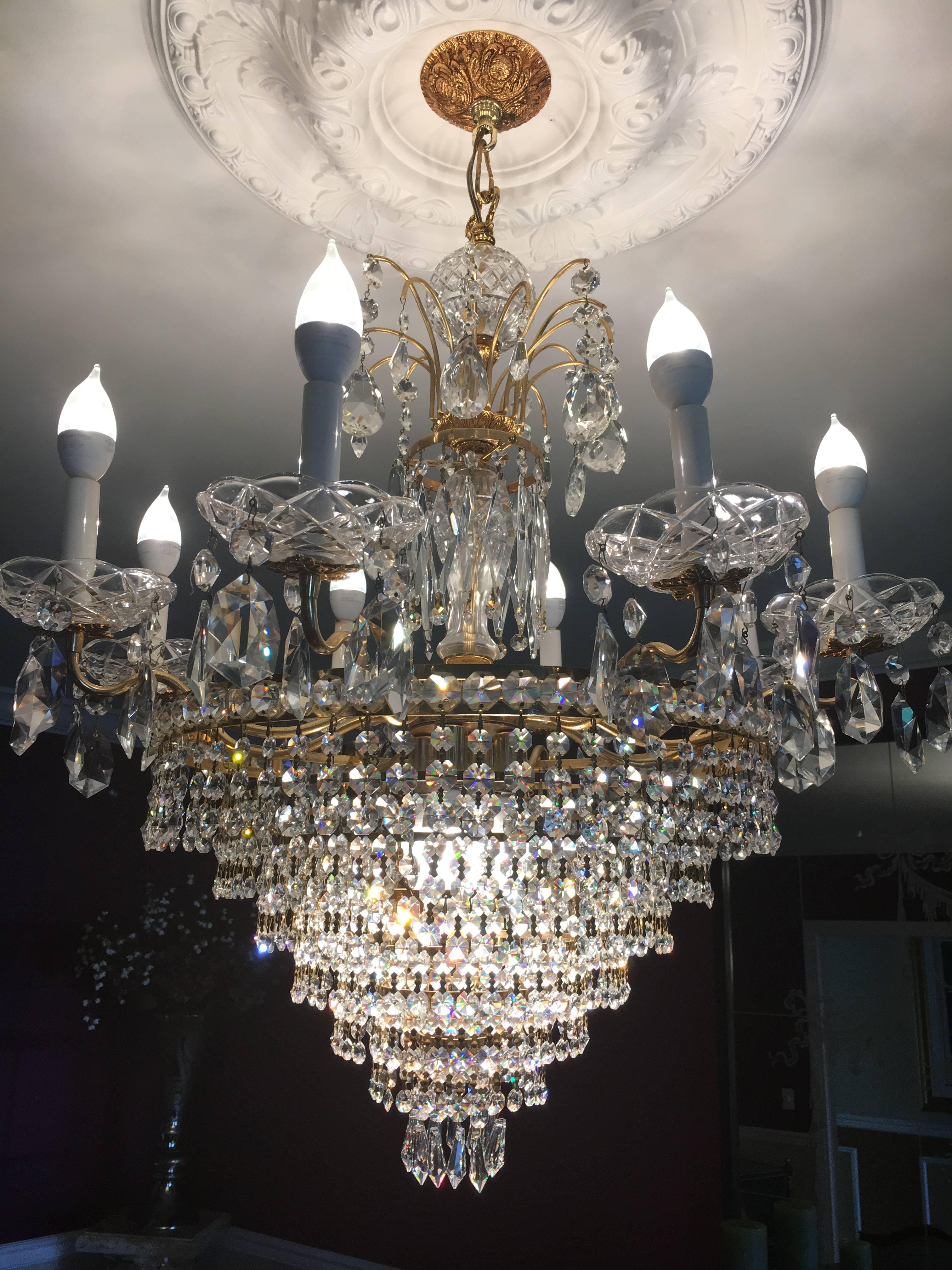 Possible Swarovski tiered chandelier. Located in our Garden City Location is this multiple tiered chandelier having what appears to be Swarovski crystals. The gilt brass connections holding each single finely cut crystal in place. Having eight
