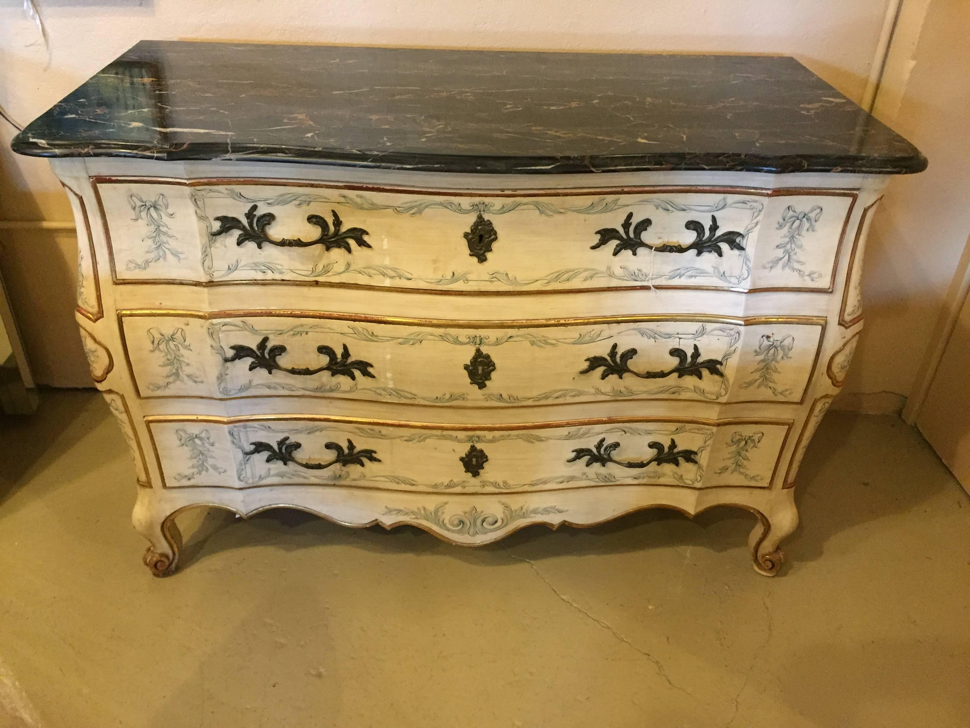 John Widdicomb made in England pair of painted Bombe marble-top chests. Each chest with oak secondaries in the Louis XV Fashion having painted leaf, vine and scroll design on an off-white background. The locks marked Made in England the drawer sides
