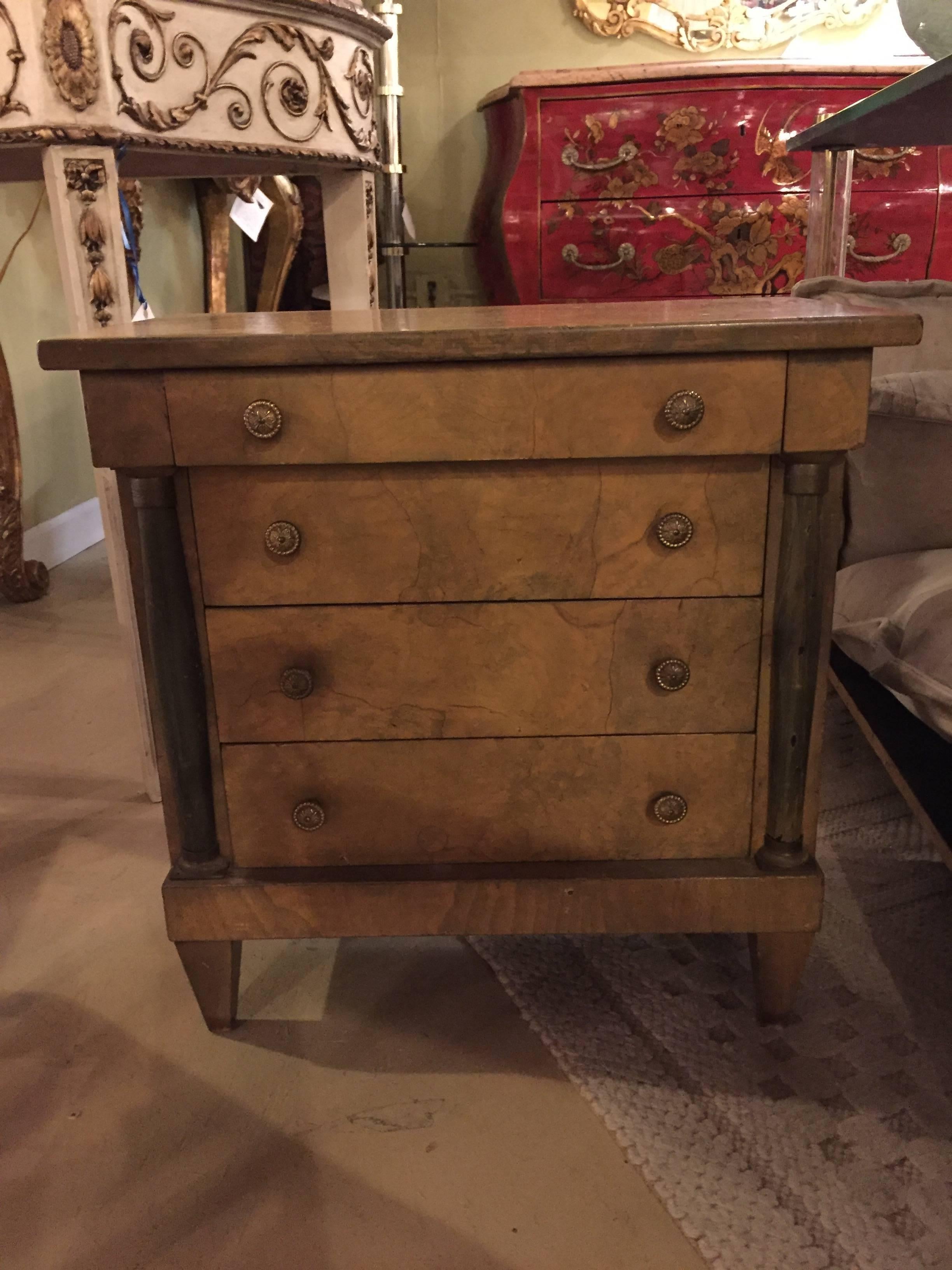 Diminutive chest of drawers salesmanship sampler. This fine handcrafted salesman sampler consists of four drawers flanked by ebonized columns having bronze caps and bottoms. Having its original worn burl finish this mini chest commode is sure to