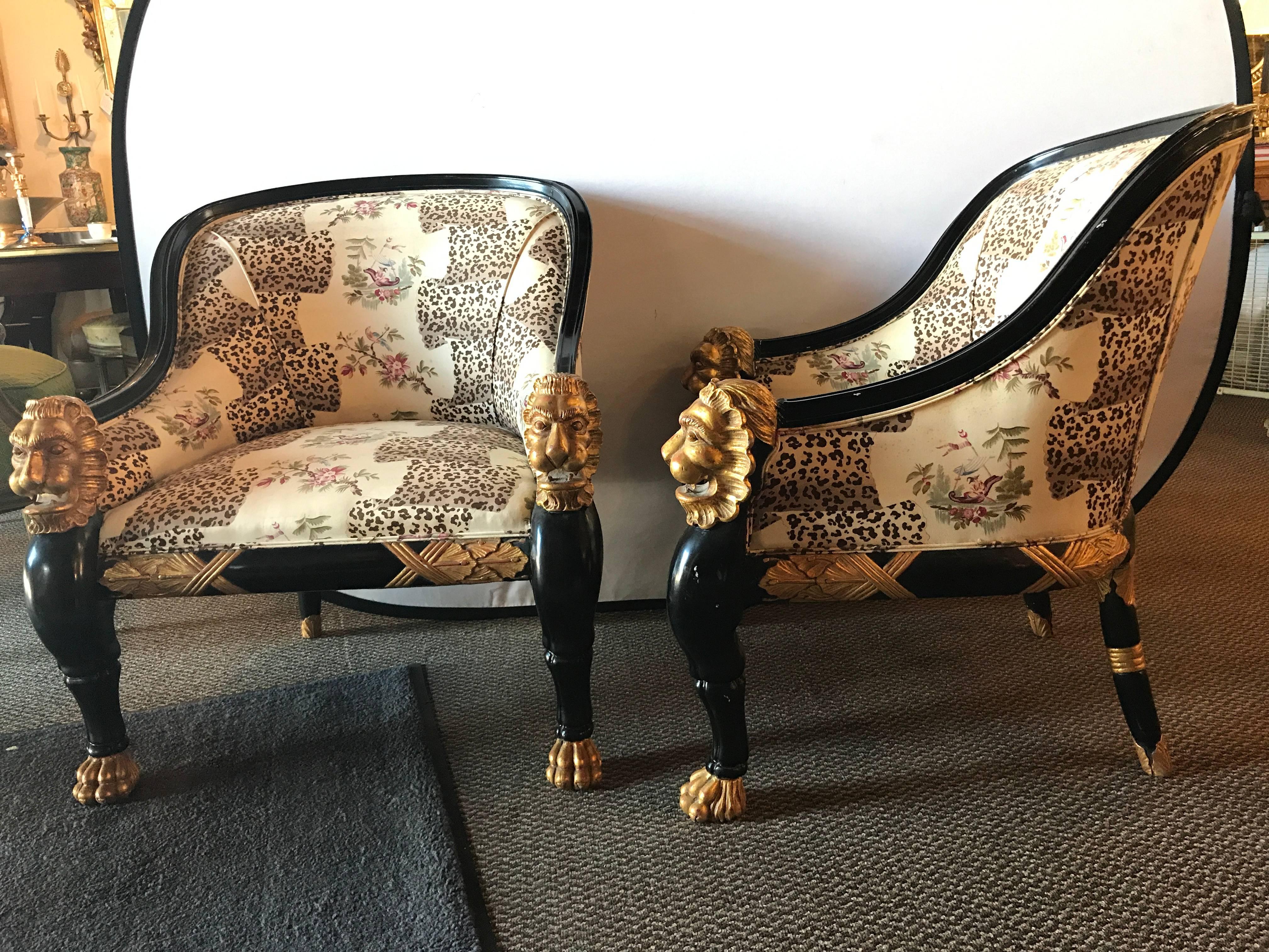 Custom quality pair of lion head rest ebonized armchairs by Maison Jansen. This fantastic pair of armchairs each barrel back in form with ebonized frames and lion form bodies. The hand rests having wonderfully detailed lion head with full manes of