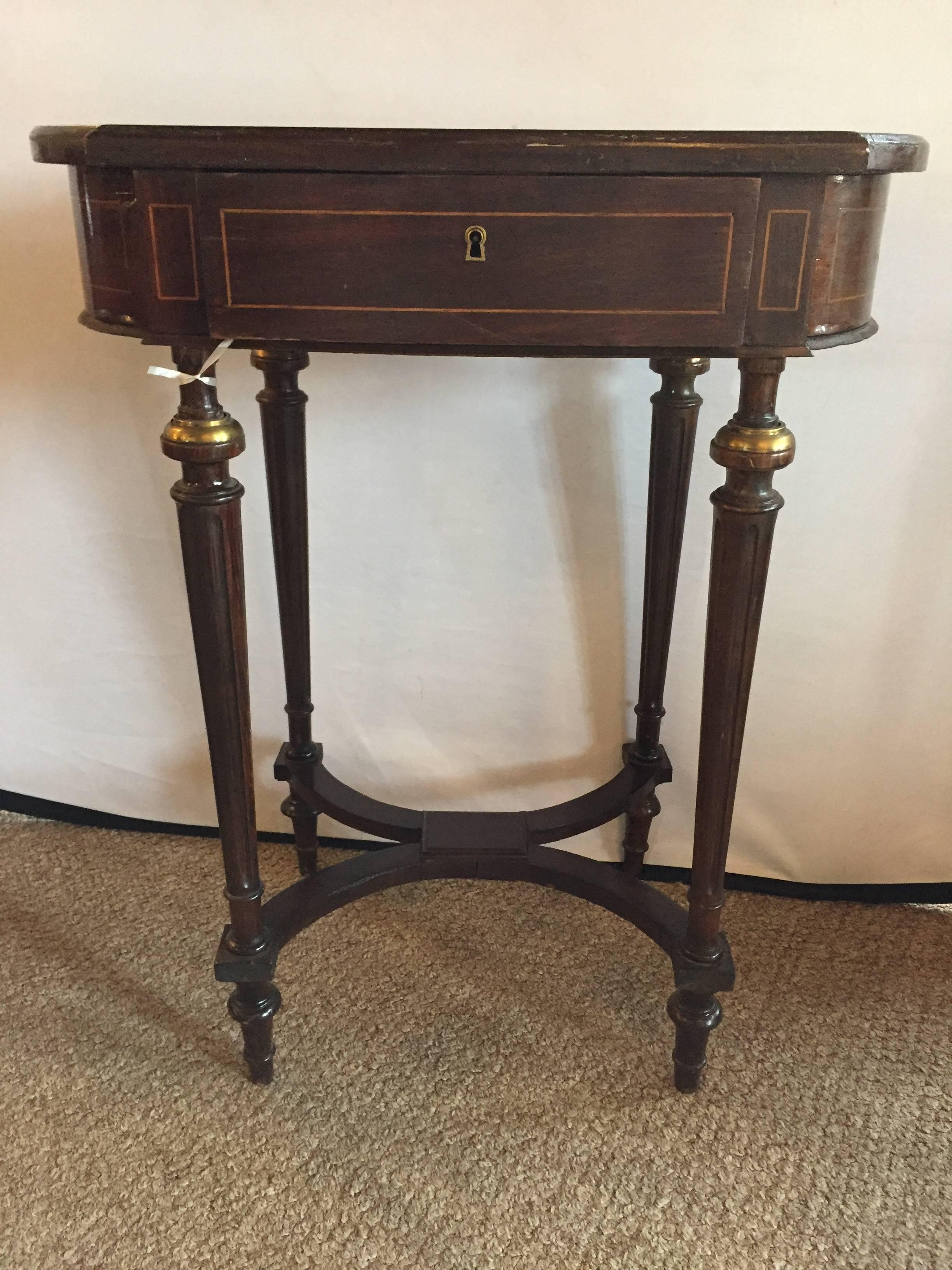 An antique inlaid floral writing desk with bronze mounts in the Louis XVI fashion with bronze-mounted tapering legs having an X form undercarriage supporting a single drawer pull up top with fitted interior.