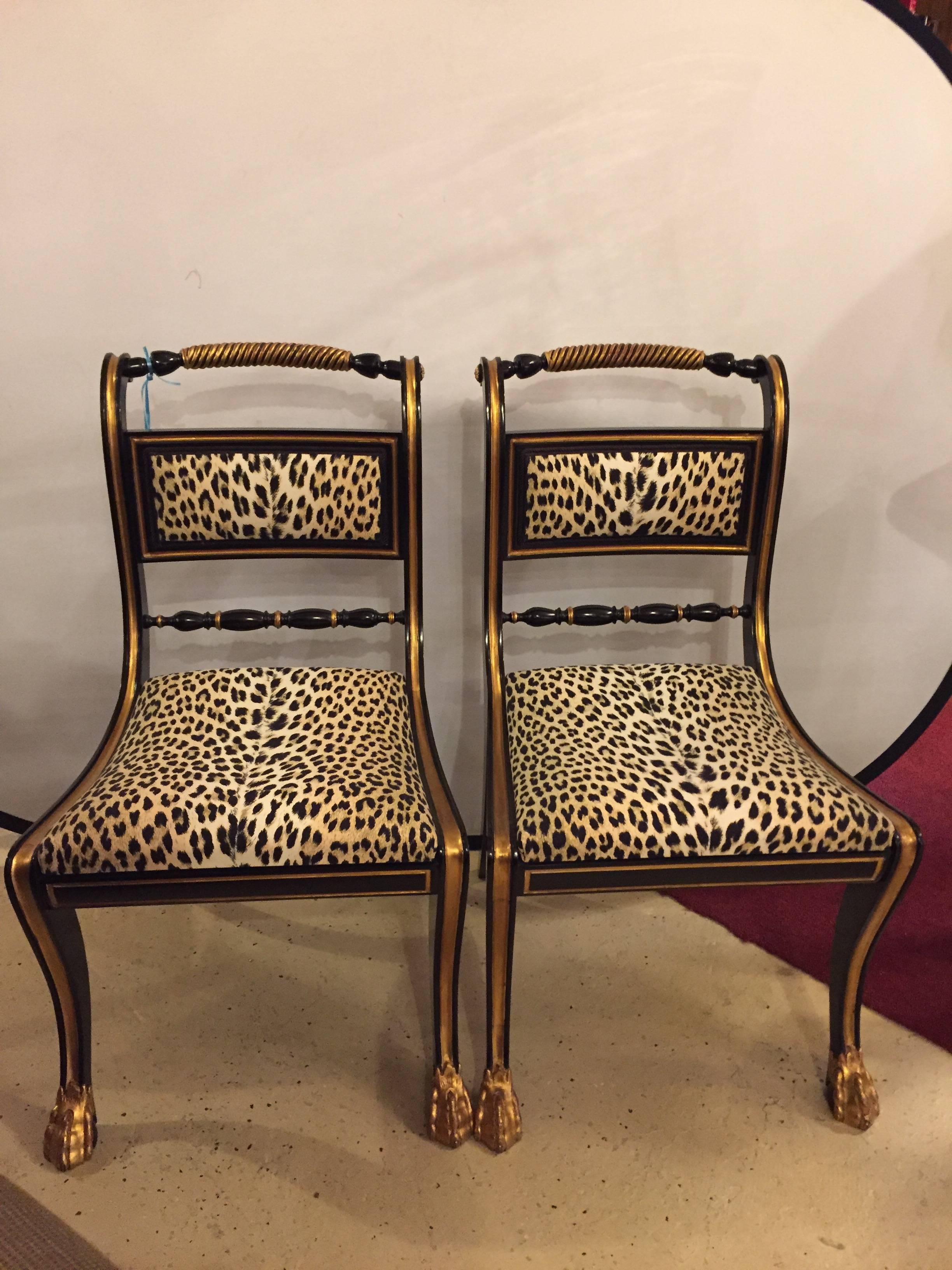 A fine  Set of 10 Ebonized and Gilt Gold Side Chairs. Two are for sale in this listing, all eight available. Each with a gilt claw foot leading to a curved leg with gilt design flowing onto an apron of matching form. The leg continuing to the seat
