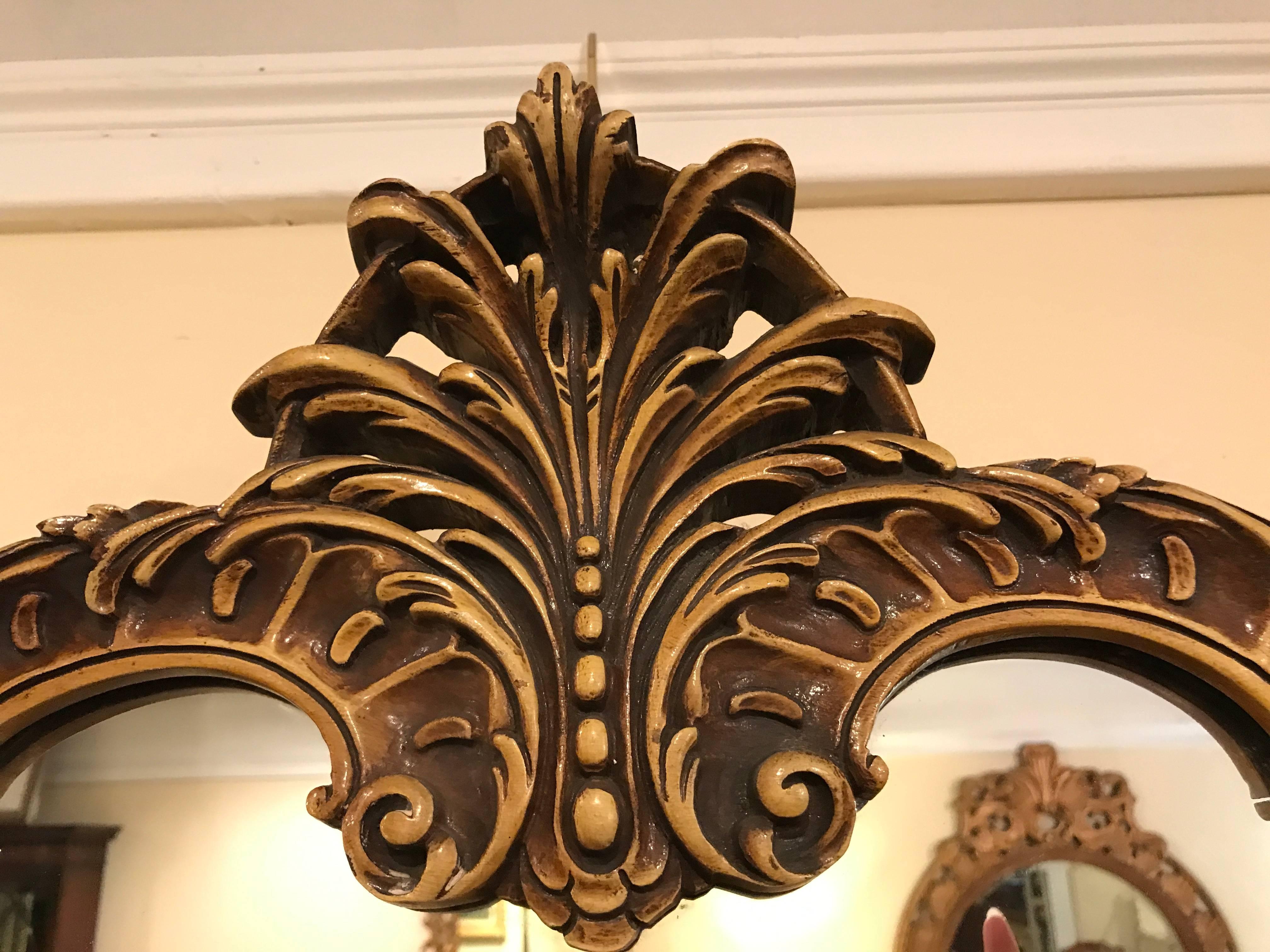 Pair Italian gilt and distressed decorated Italian wooden mirrors. Each having all around shell and sway carvings with rosettes and a finely distressed finish.