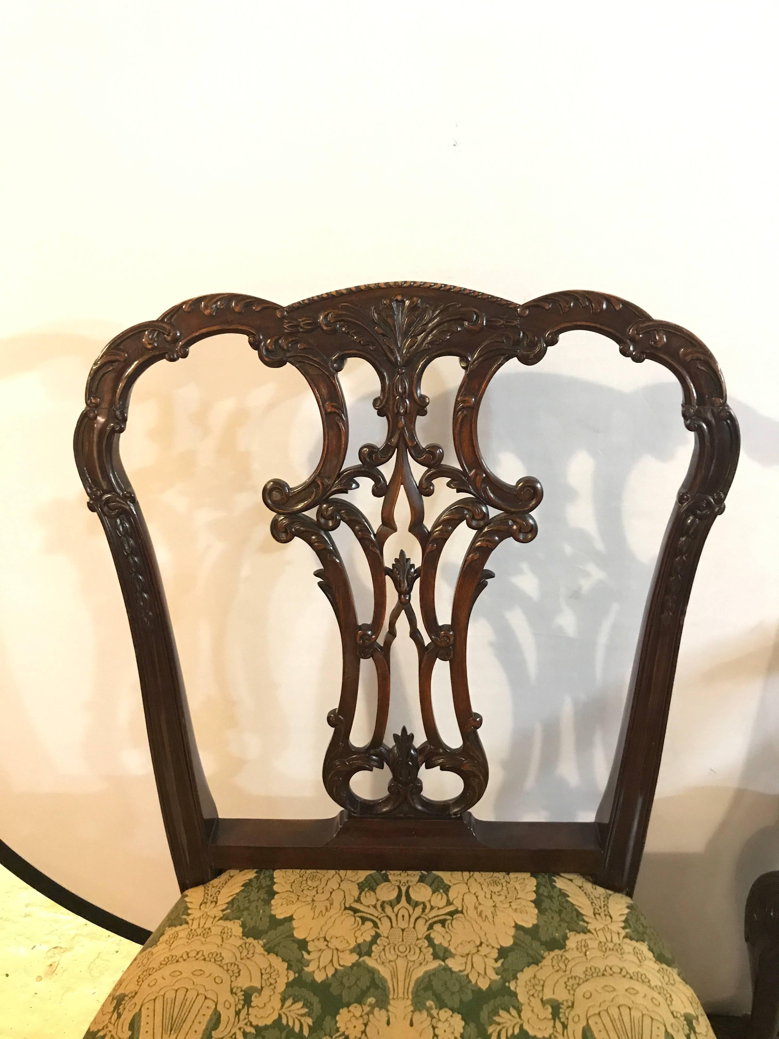 Set of eight Georgian style solid mahogany dining room chairs. Custom-made possibly Baker or Schmieg and Kotzian. This fine set consists of two arm and six side chairs each having a finely carved ball and claw foot leading to a cabriole leg. The