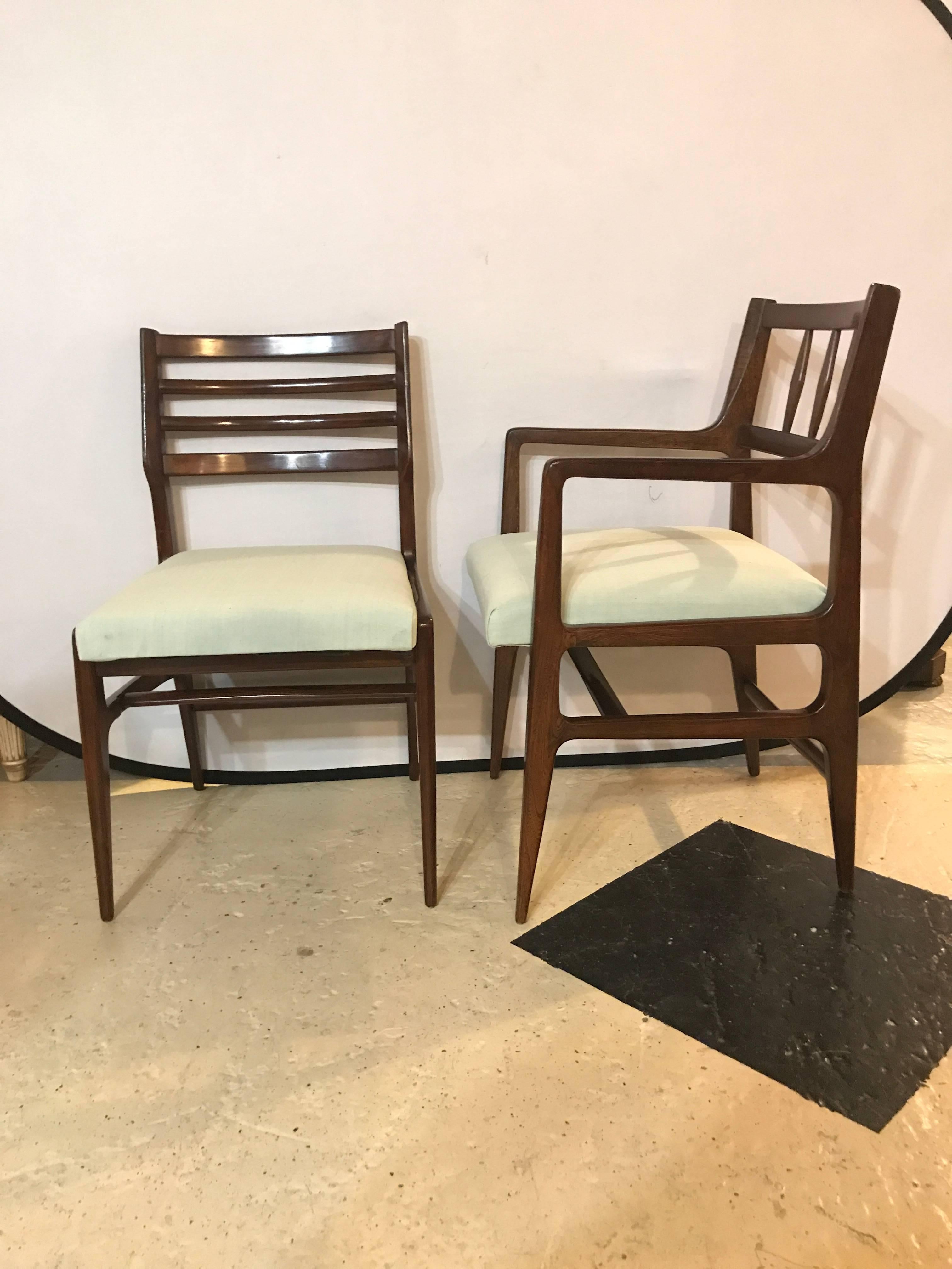 Set of six (two arm four side) dining chairs by R'way furniture in a rosewood finish. This fine set of Mid-Century Modern Dining chairs have been recently recovered in a greenish linen fabric. The sleek and subtle lines define the Mid-Century Modern
