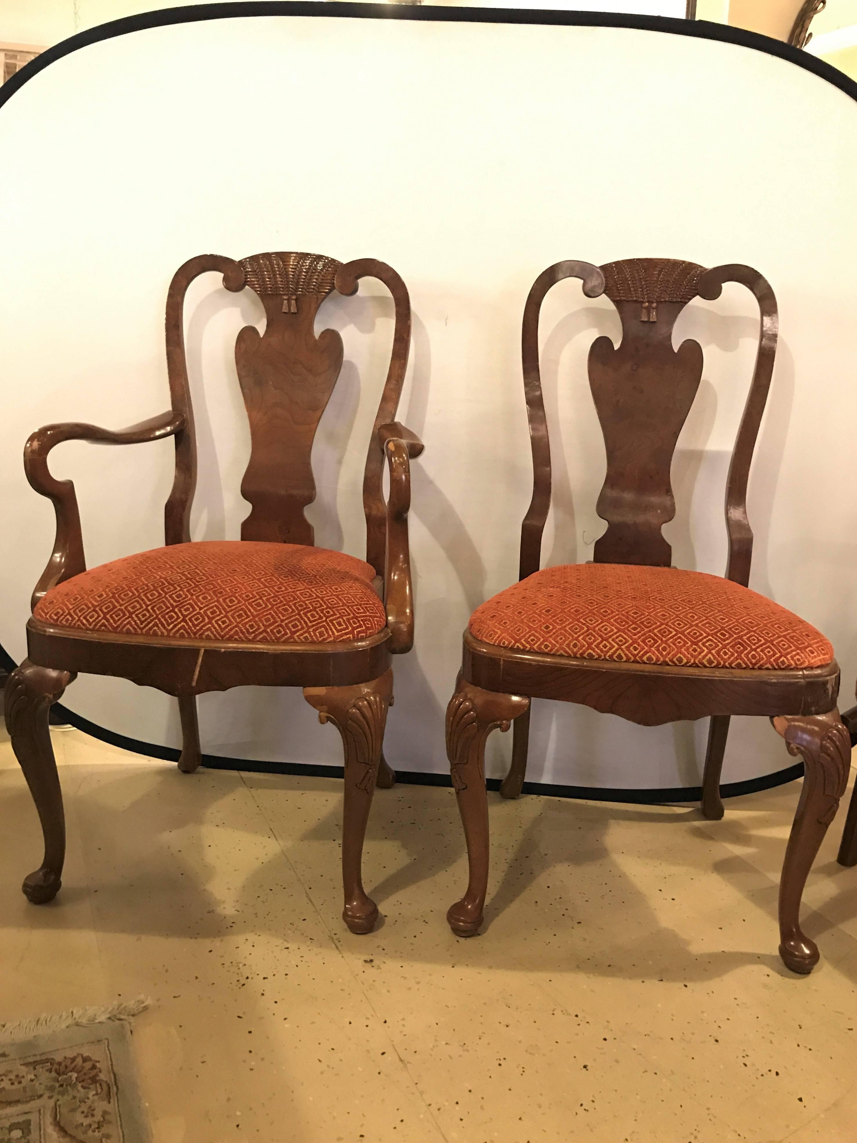 Set of ten Queen Anne style dining room chairs. A pair of arm and eight side chairs comprise this fine custom quality set of chairs. Each in a rich burl wood frame with carved turned feet leading to cabriole legs. The thick solid apron supporting an