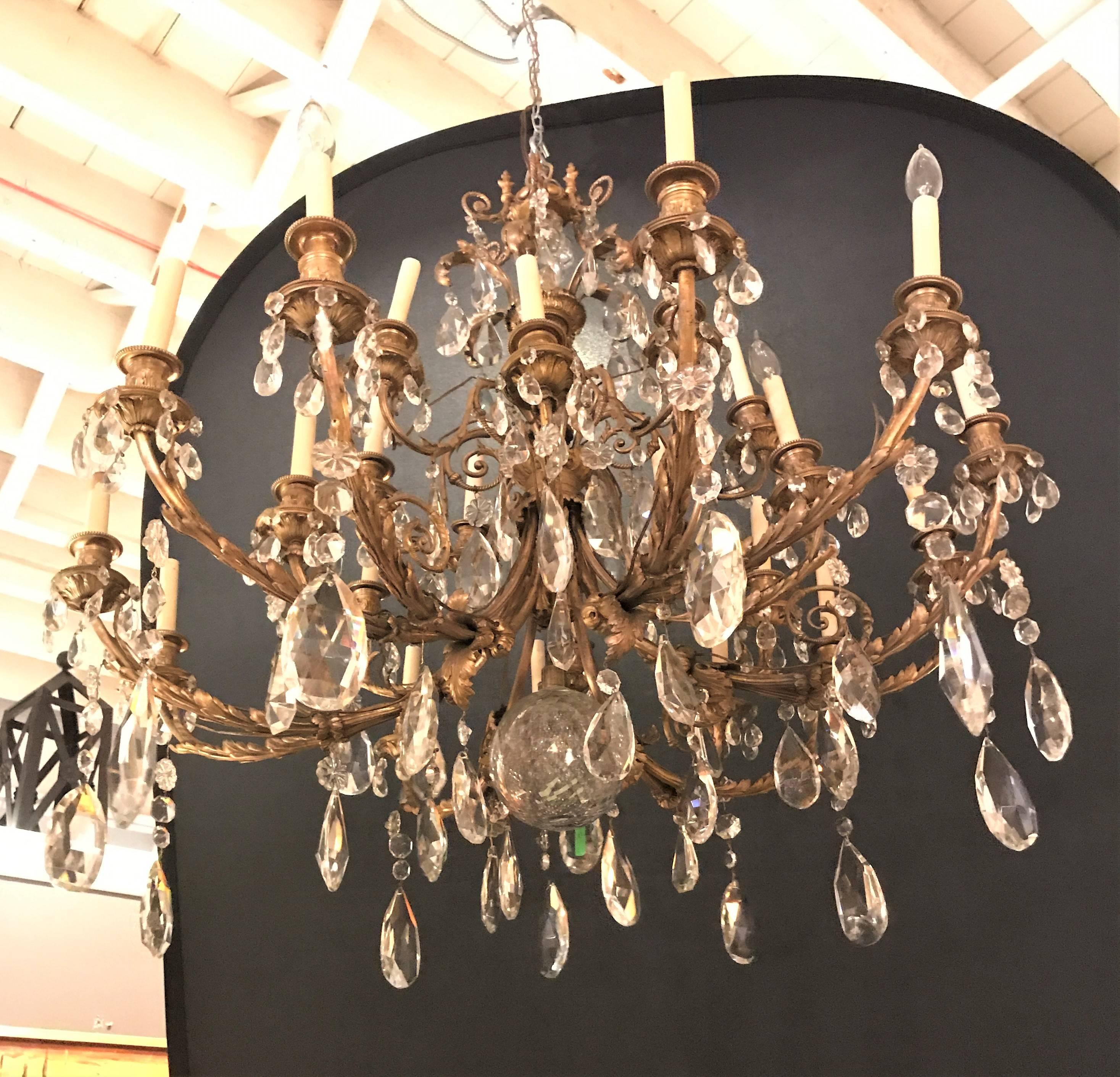 19th century French doré bronze and fine crystal chandelier. Prov: Doyle Galleries NY. This monumental bronze swag and scroll design chandelier has large and simply stunning crystals. The chandelier needs to be re-wired. This is an estate sale