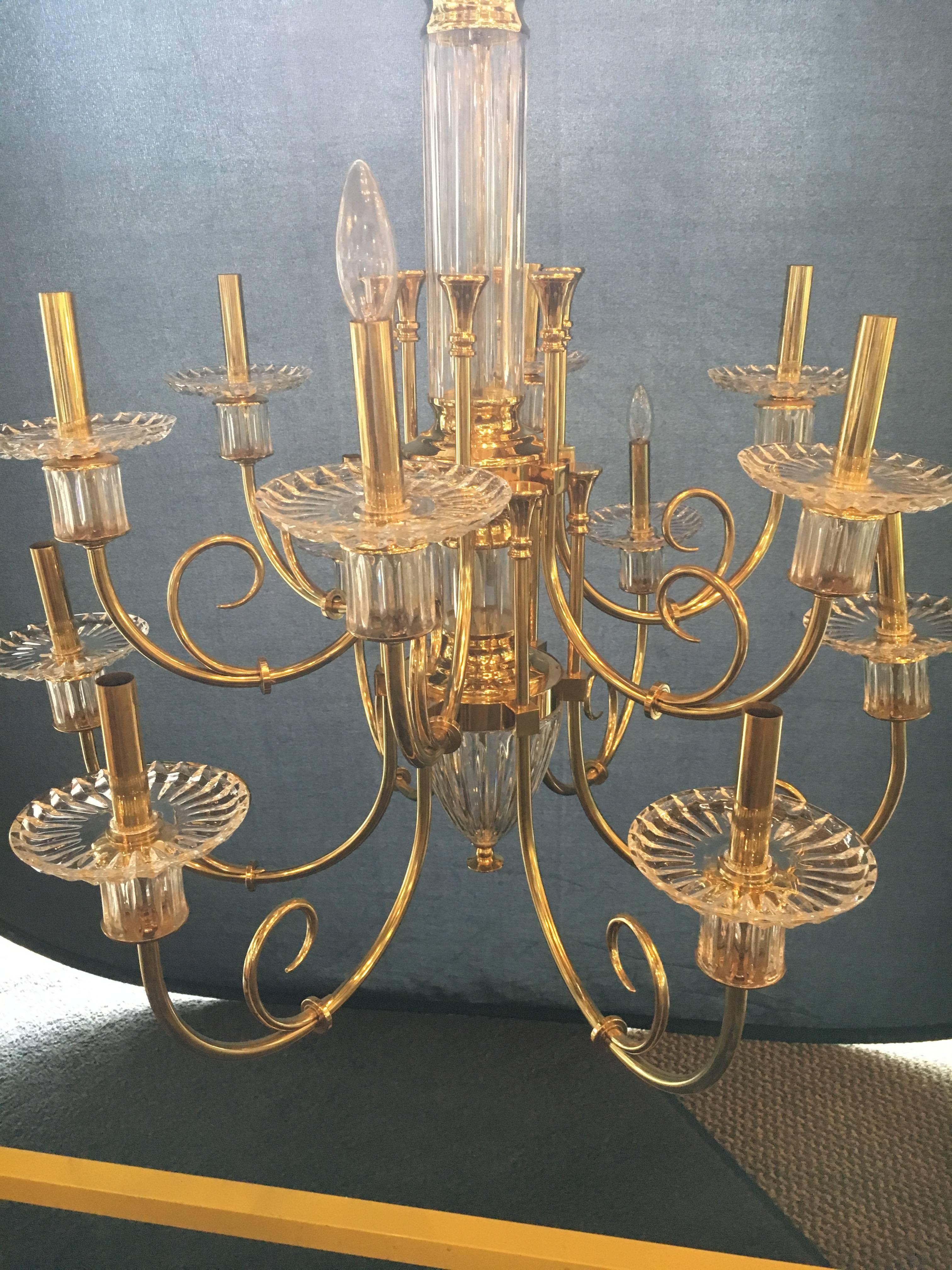 Custom quality at its finest. This highly decorative 12-light bronze and cut crystal chandelier with chain and crystal canopy are sure to light up any room. In a word this Hollywood Regency style chandelier is too sweet. The crystal and bronze