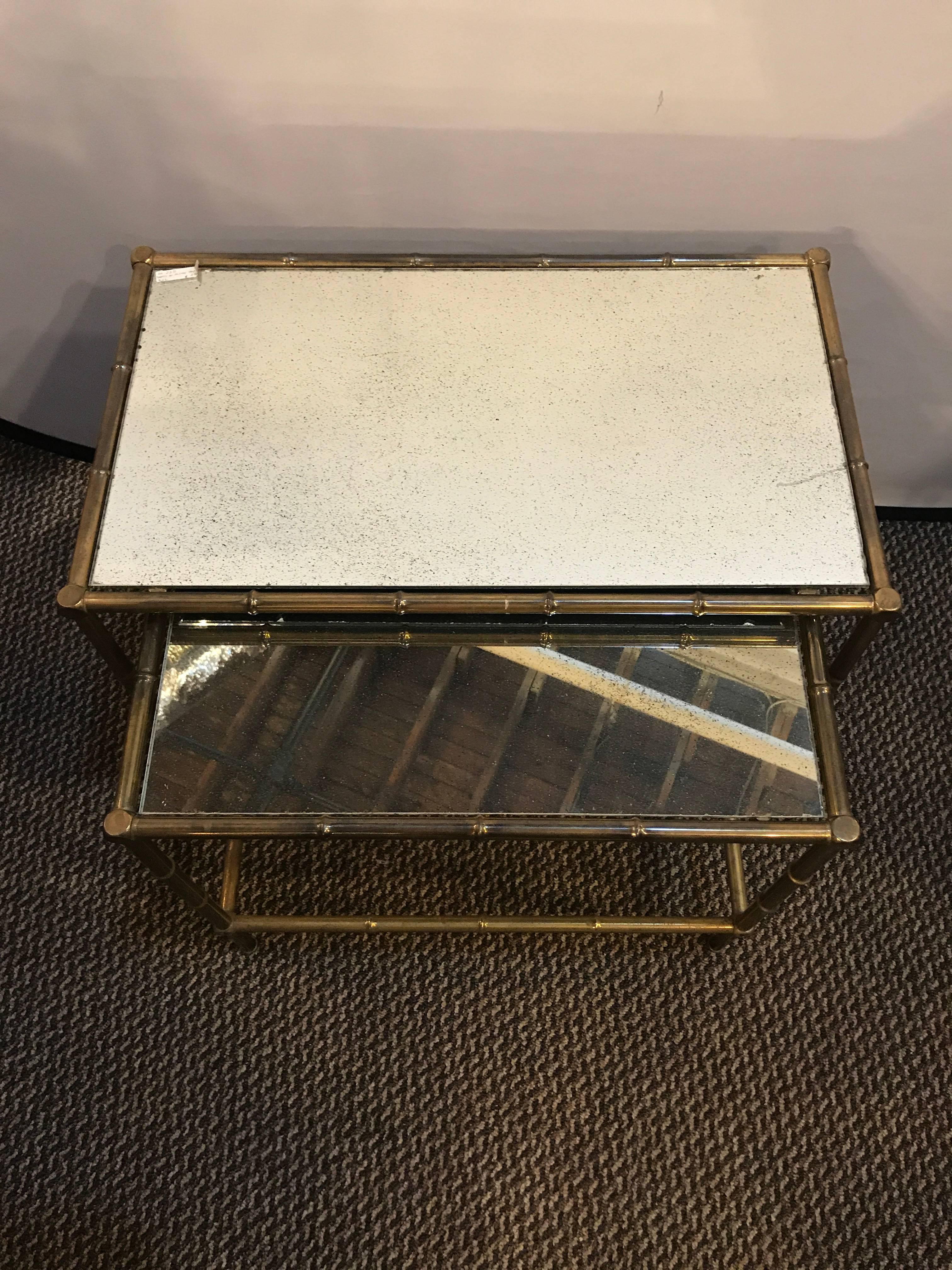 A brass nest of tables with mirror tops in bamboo form.

Measurements for the tables:
Big table H 19, W 24.5, D 4.25 
Small table H 17.75, W 20.75, D 13.5.