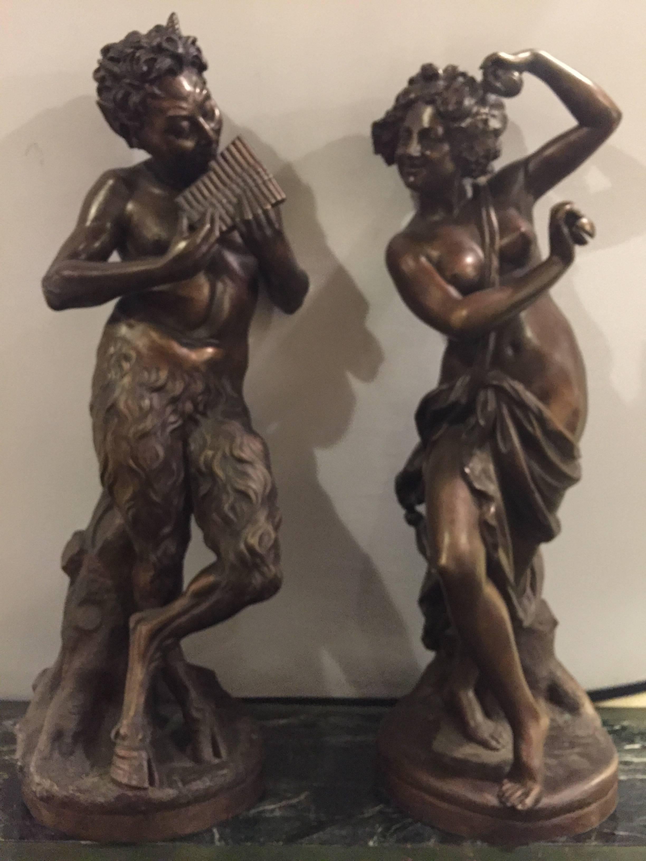 Pair of large bronze mythological figures male and female dated 1914 and signed. Pan and his lady in fine detailed form dated 1914. These enormous statues are sure to add conversation to any room that they are placed in.