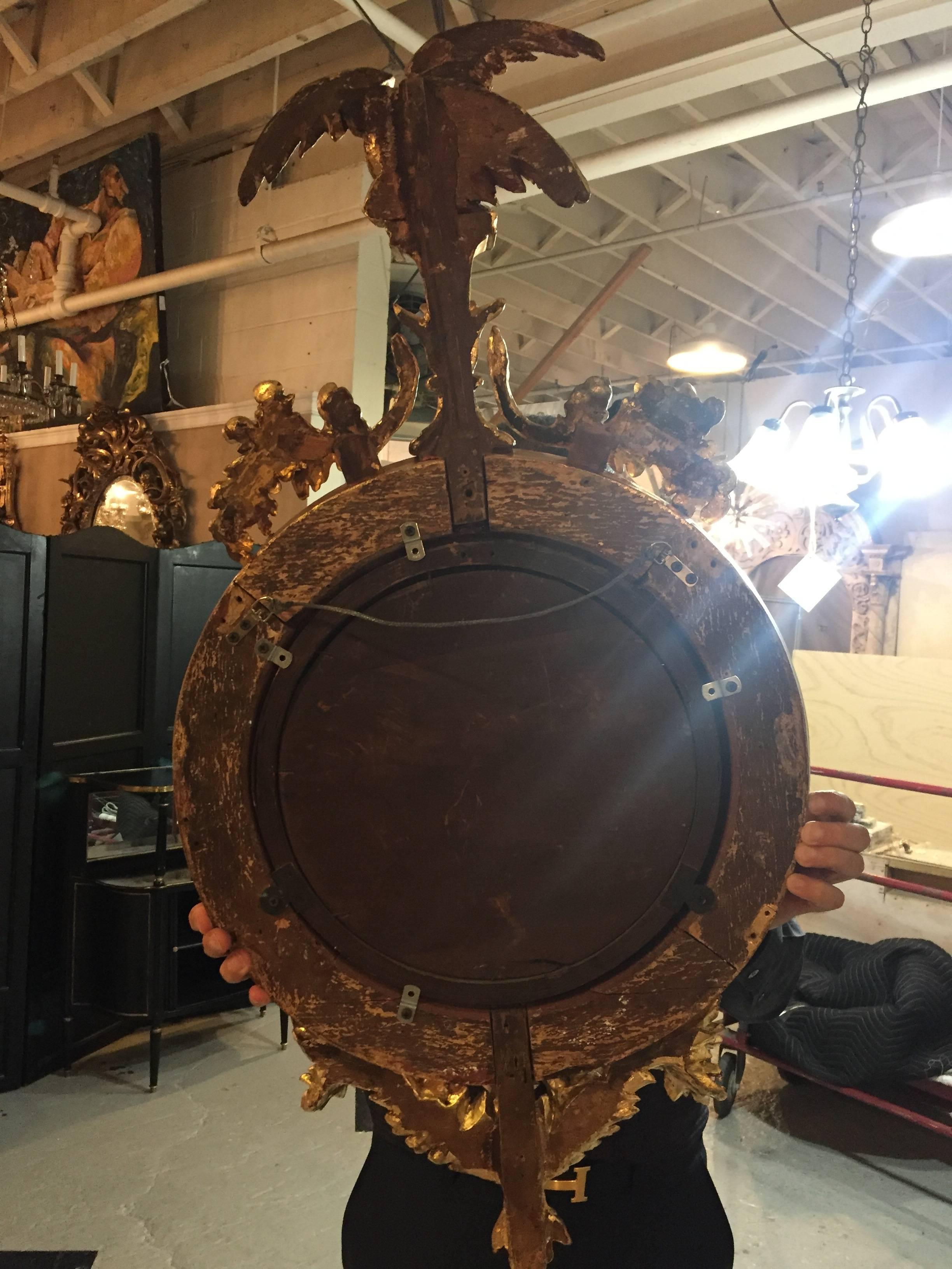 Federal Style Convex Mirror Ebony and Gilt Adorning an Eagle Winged Crest In Good Condition In Stamford, CT