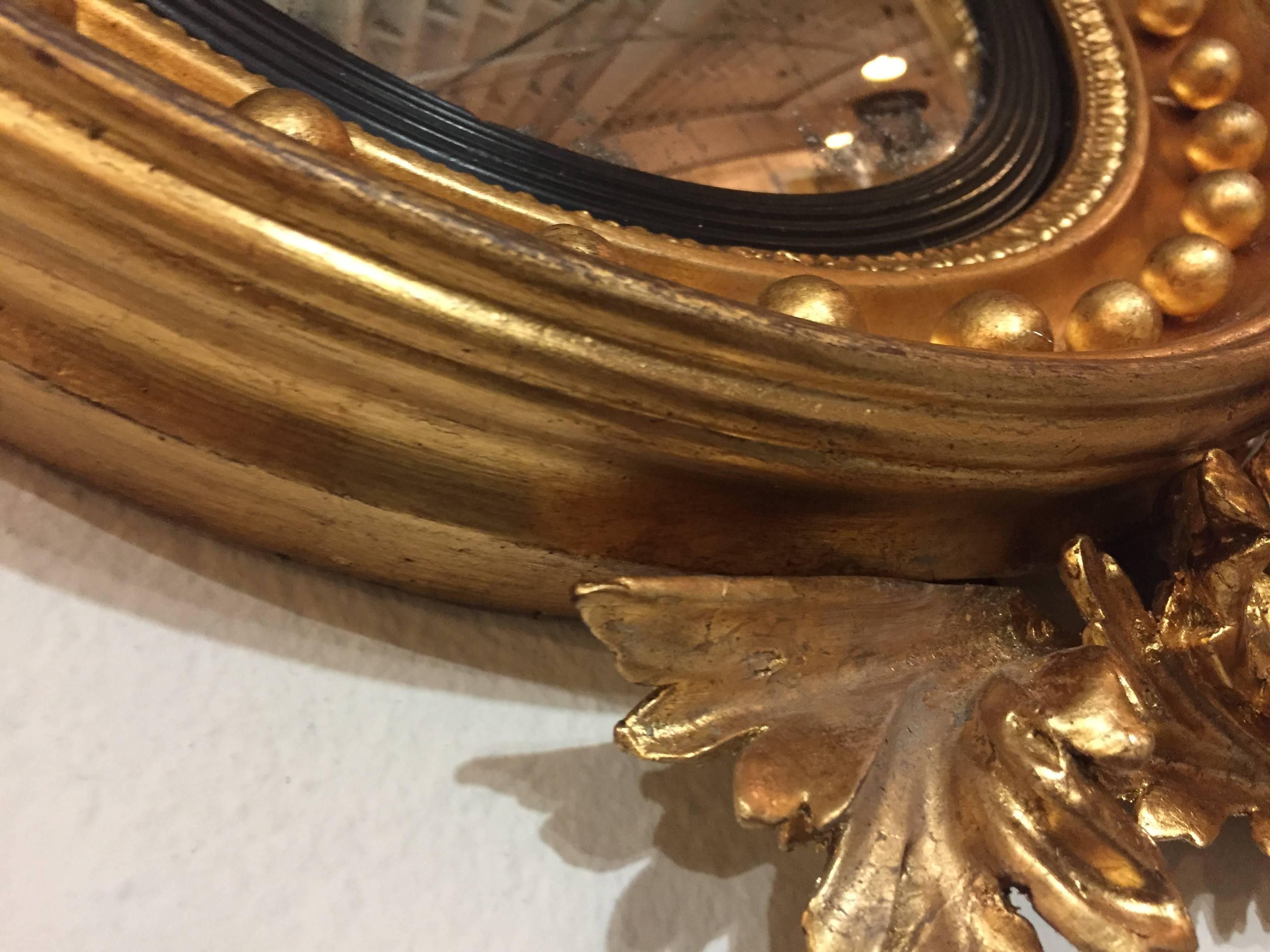 Federal Style Convex Mirror Ebony and Gilt Adorning an Eagle Winged Crest 1