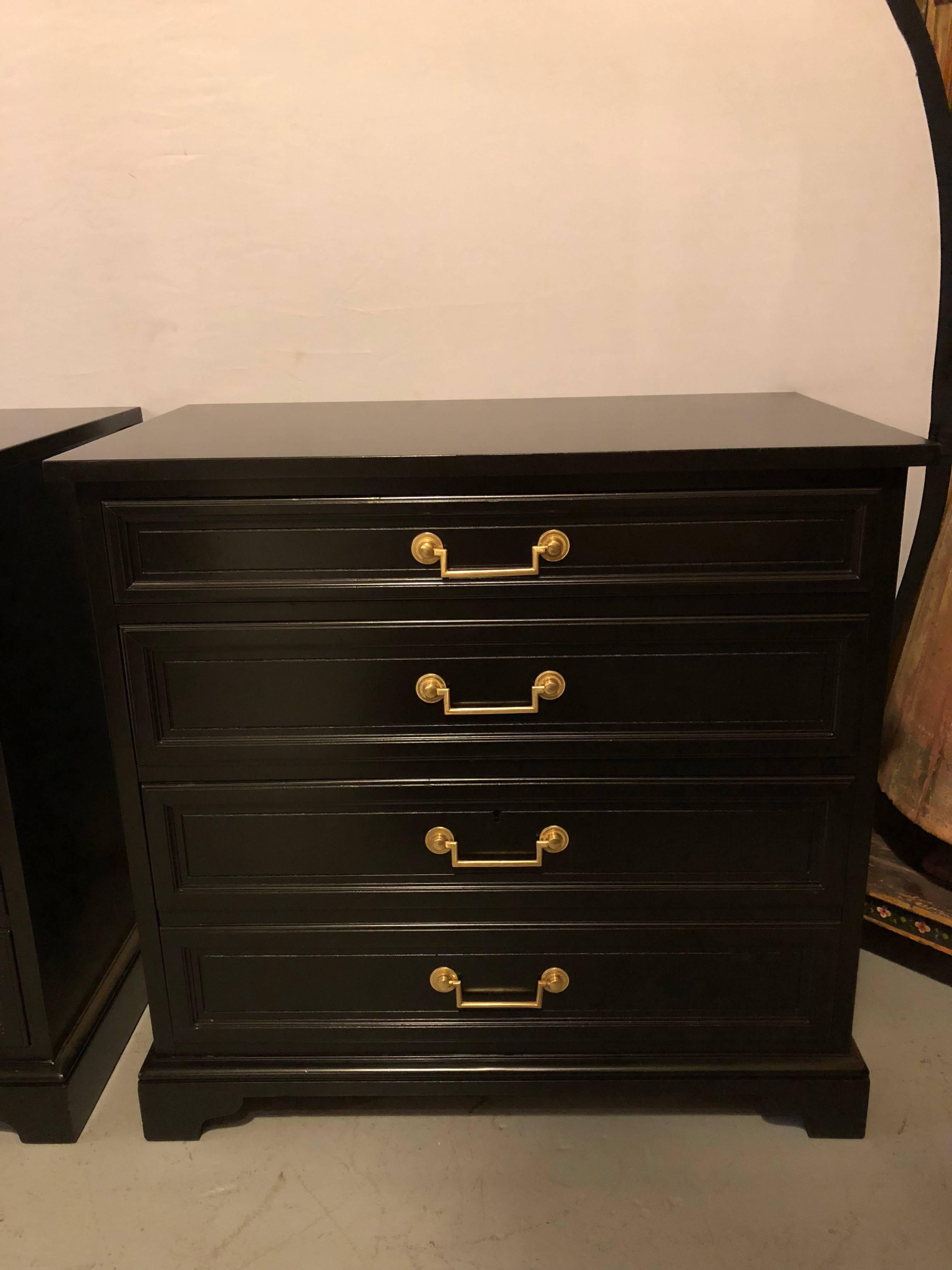 Pair of ebony office chests by Baker Furniture company with solid brass handles. Each Hollywood Regency style chest having that Baker quality with oak secondaries. The four drawer appearance having lower file cabinet holder as well as an incredible