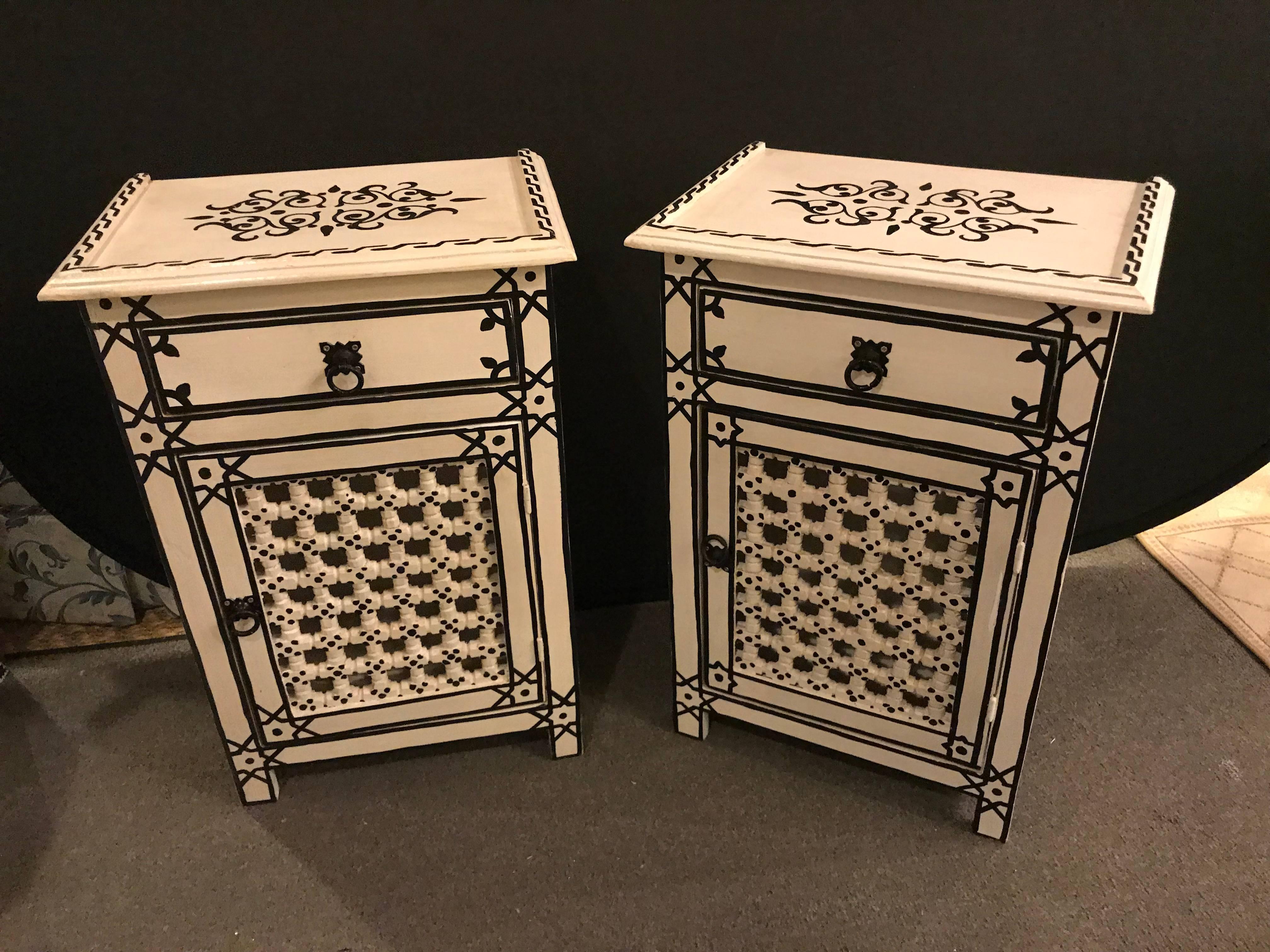 Pair of hand-painted Moroccan nightstands / end tables. Hand-painted by master artisans , this stunning pair of Moroccan nightstands features an interior cavity for storing personal items and impresses with its unique design and a welcoming black