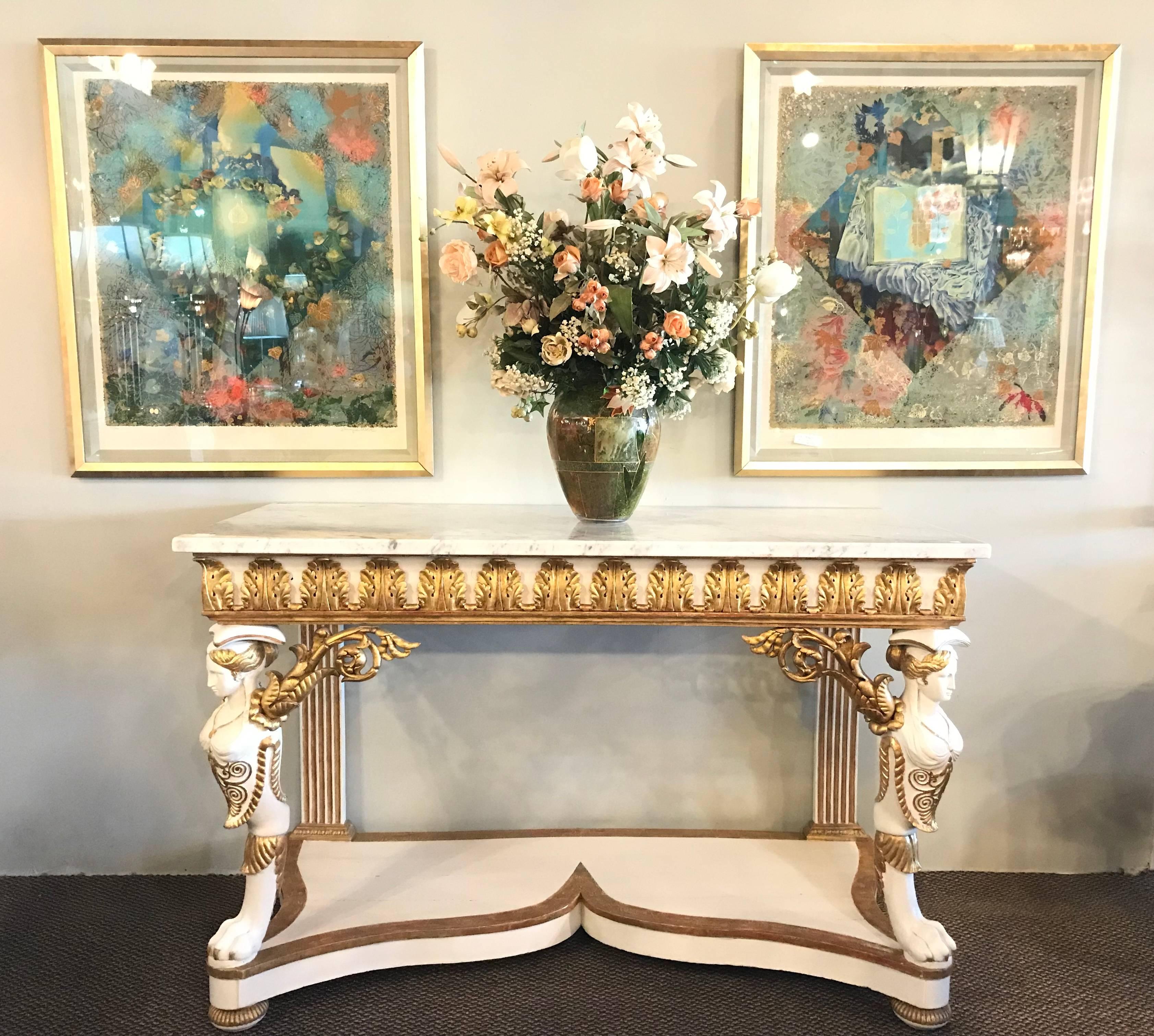 Simply stunning Italian Empire white painted and parcel-gilt decorated console table, circa 1825. The white marble rectangular top above an acanthus carved frieze, raised on female monopodiae flanked by acanthus carved pierced scroll brackets, the