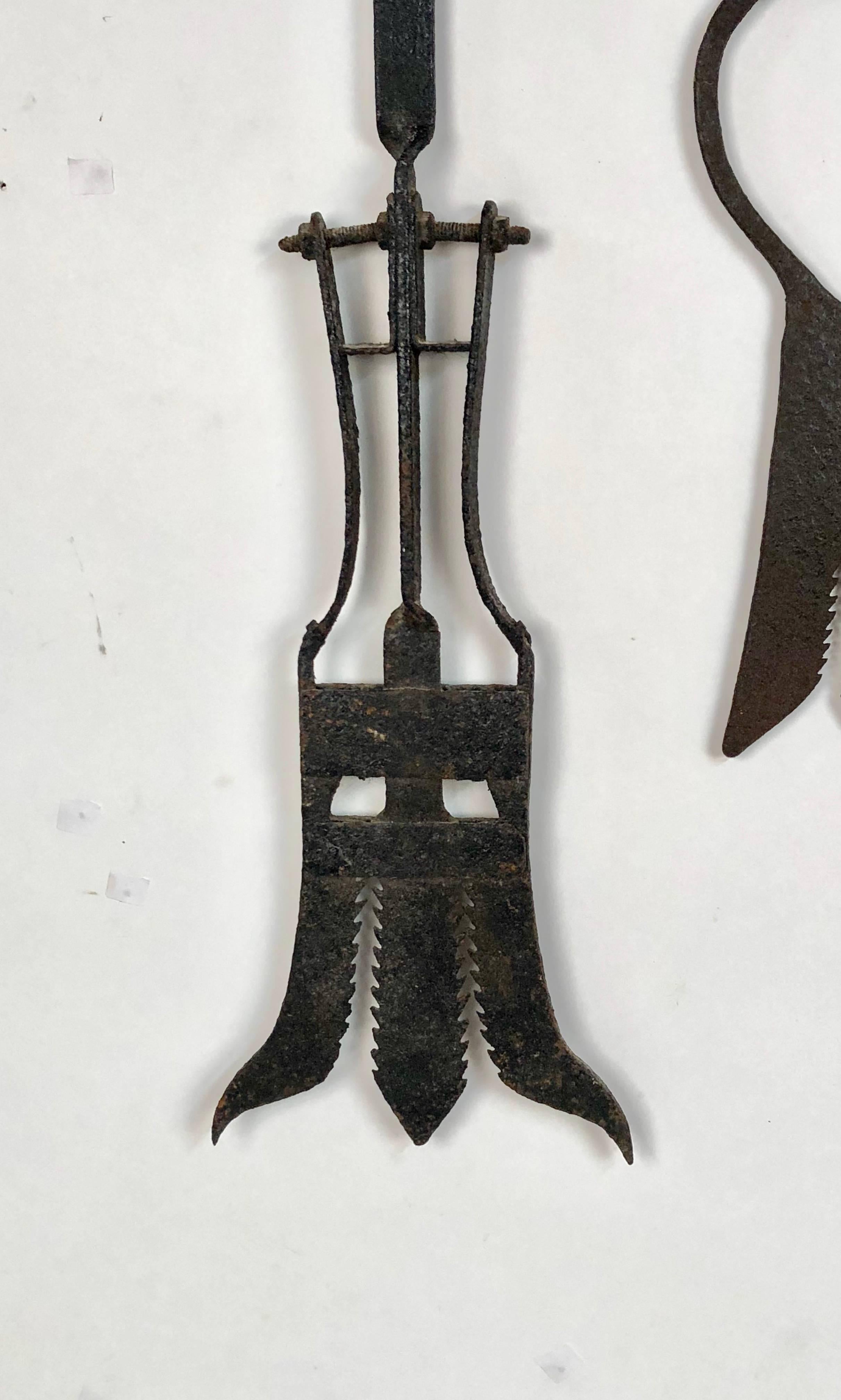 A collection of five Late 19th century antique hand-forged European Eel spears in various sizes. Ranging in length from 19 inches to 26 inches long. The widest of these is at 9.50 inches. This desirable set can be hung in many different styles to