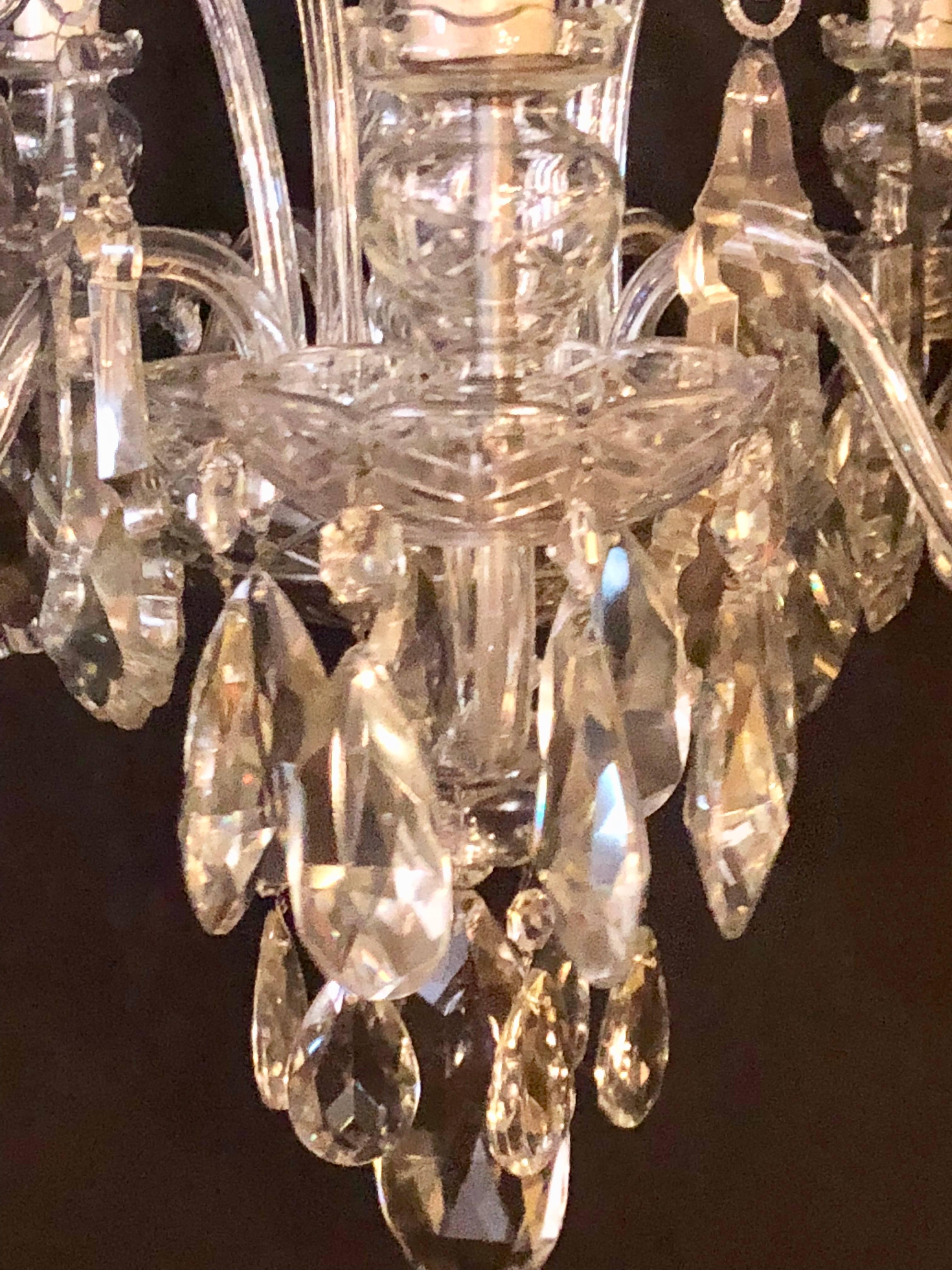 Fine cut crystal Georgian chandelier with large pendants. Recently repaired. The centre cut-glass column having five lighted arms with S-scroll cut-glass designs between them. The crystals of fine quality. Recently rewired. Possibly by Schonbek.