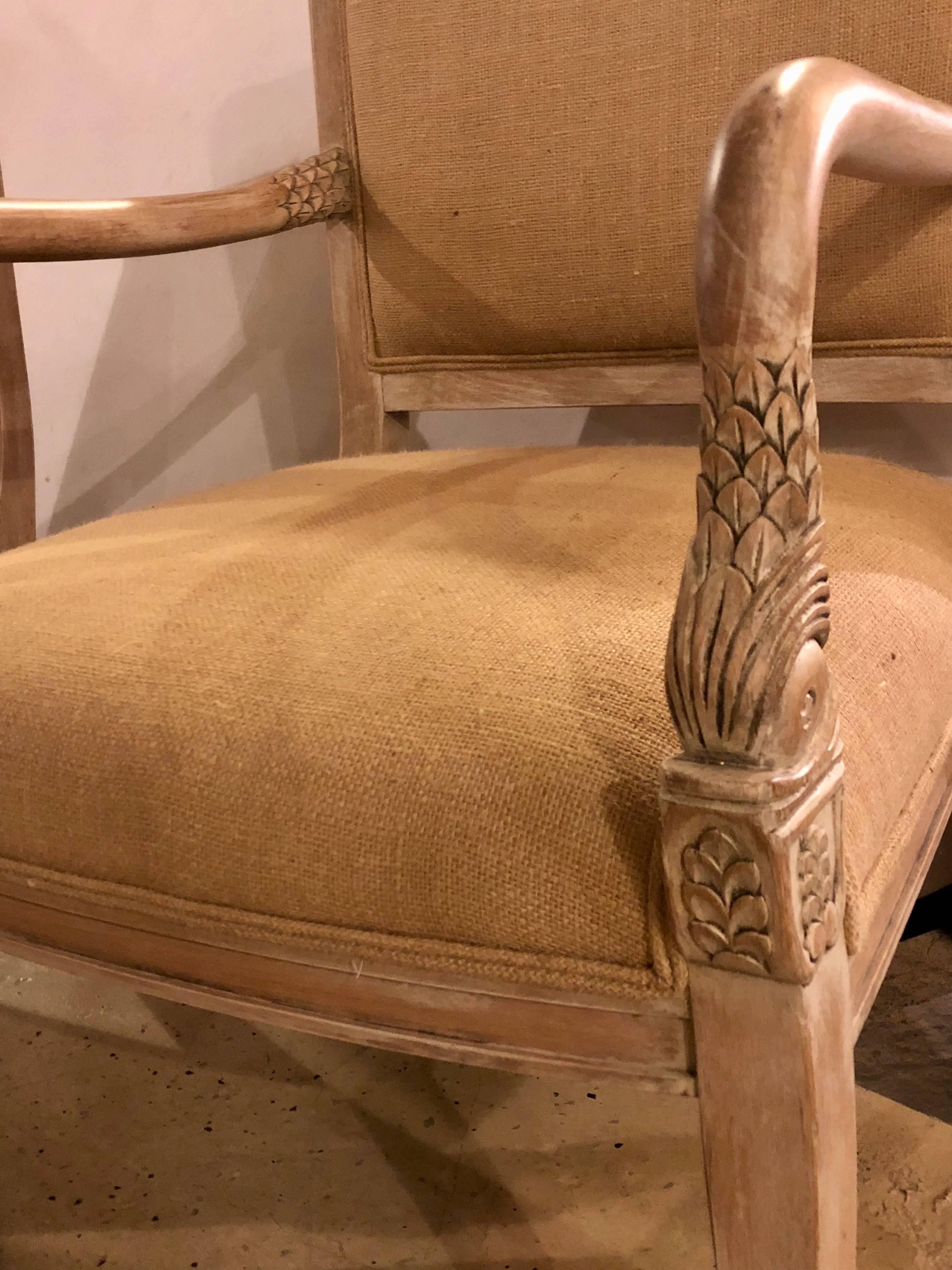 Pair of swan head finely carved pickled wood upholstered chairs. Each in a raw wood finish with new burlap upholstery.