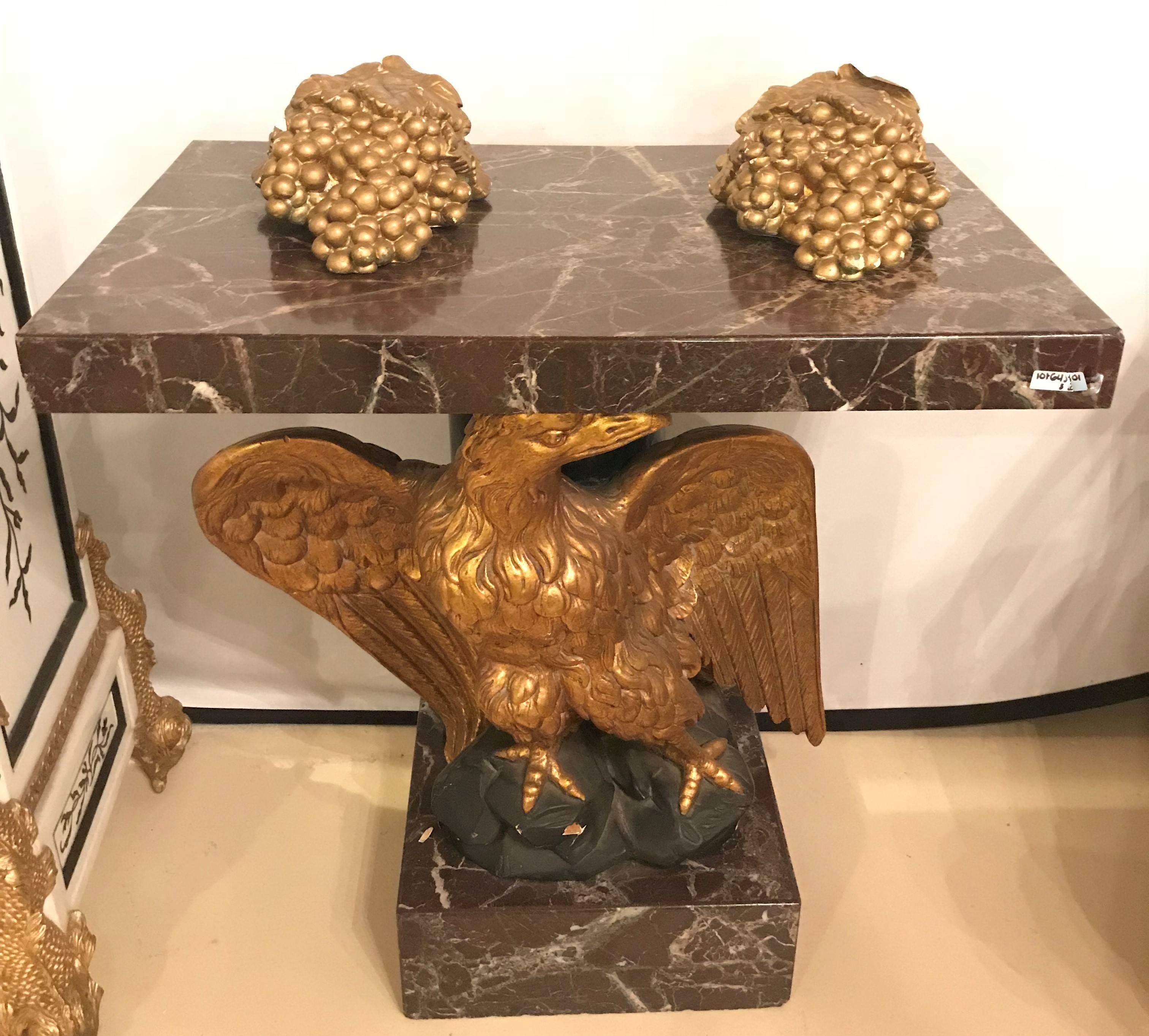 A large gilded eagle marble-top and base console or pedestal table. Federal style giltwood carved eagle pedestal table. Fabulous detail in this piece down to the eagle's claws sitting on the rocks. A marble base matching the marble-top adds to this