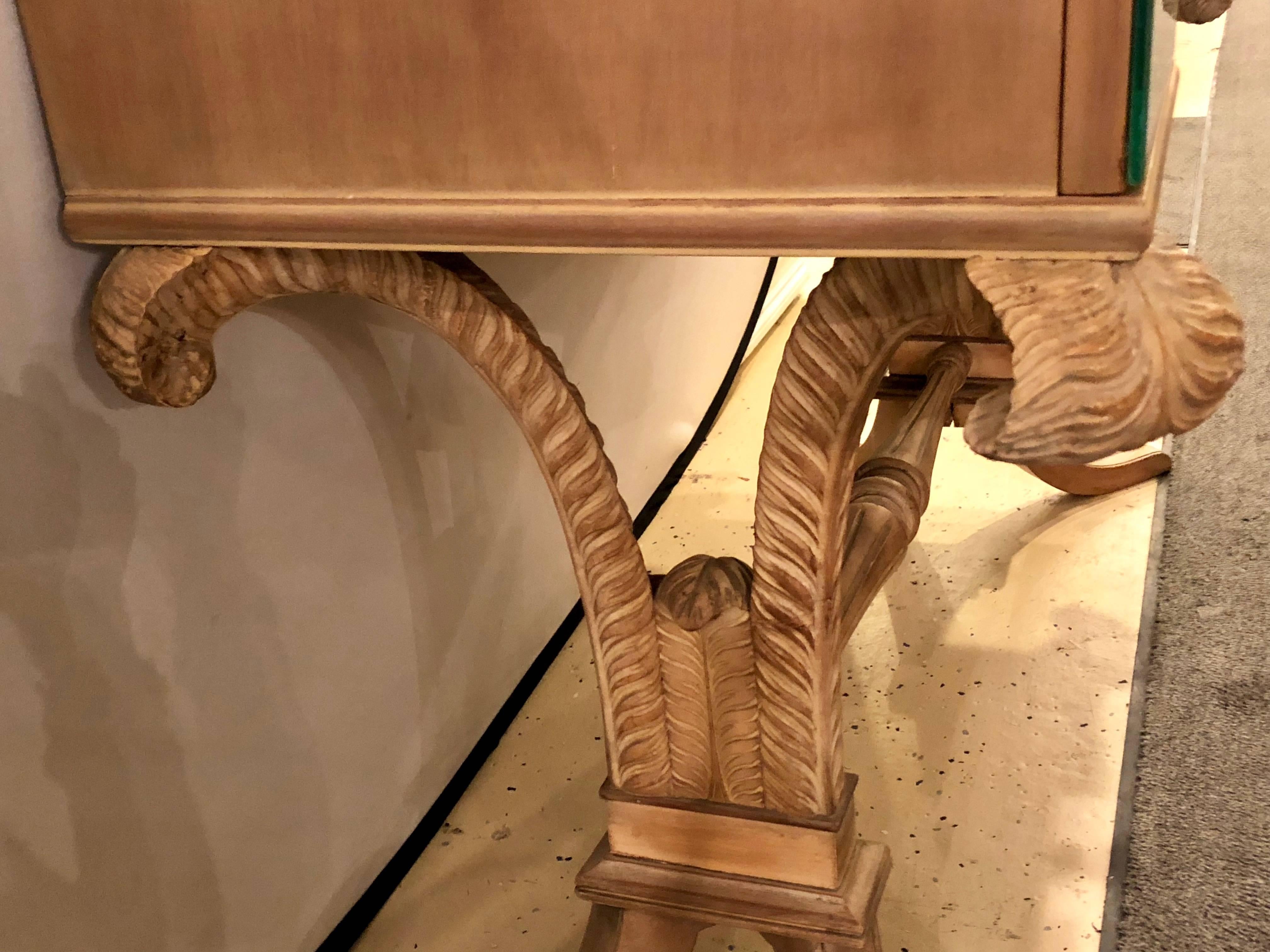 Mid-Century Modern Grosfeld House attributed plume decorated mirror and carved wood vanity. In a pickled finish comes this fine quality carved vanity or writing desk. Having sprayed legs leading to plume decorated supports under a three drawer