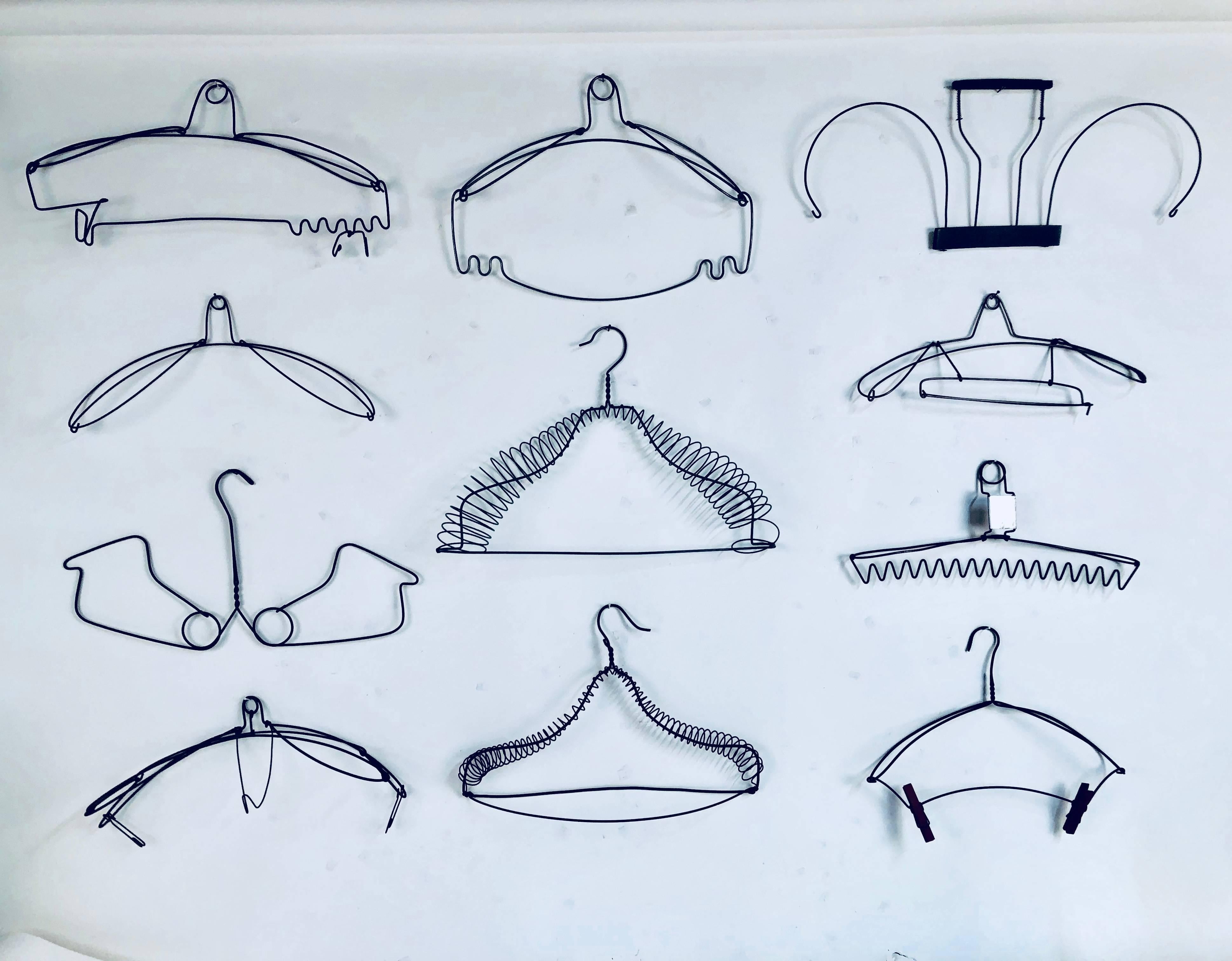 Collection of 11 antique wire hangers dating from 1880-1920. Beautiful abstract shapes. Range in size from 14.50 inches wide to 19 inches wide.