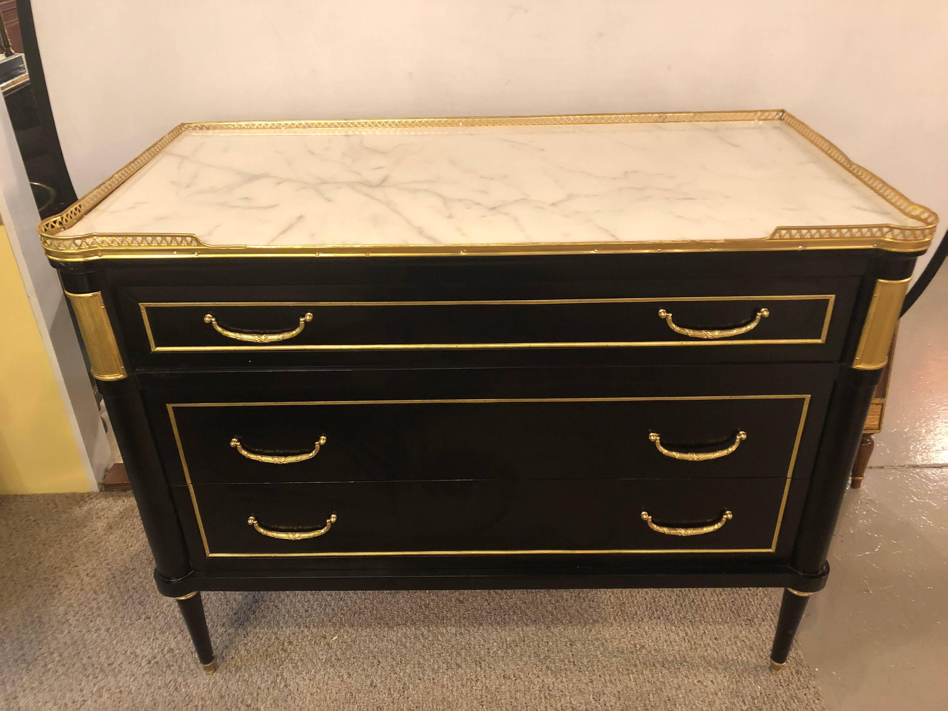 A fine pair of custom quality ebonized Louis XVI Hollywood Regency style commodes or nightstands in the manner Maison Jansen. Simply the finest in style, look, design and quality come this pair of ebony marble top commodes. The white Carrera marble