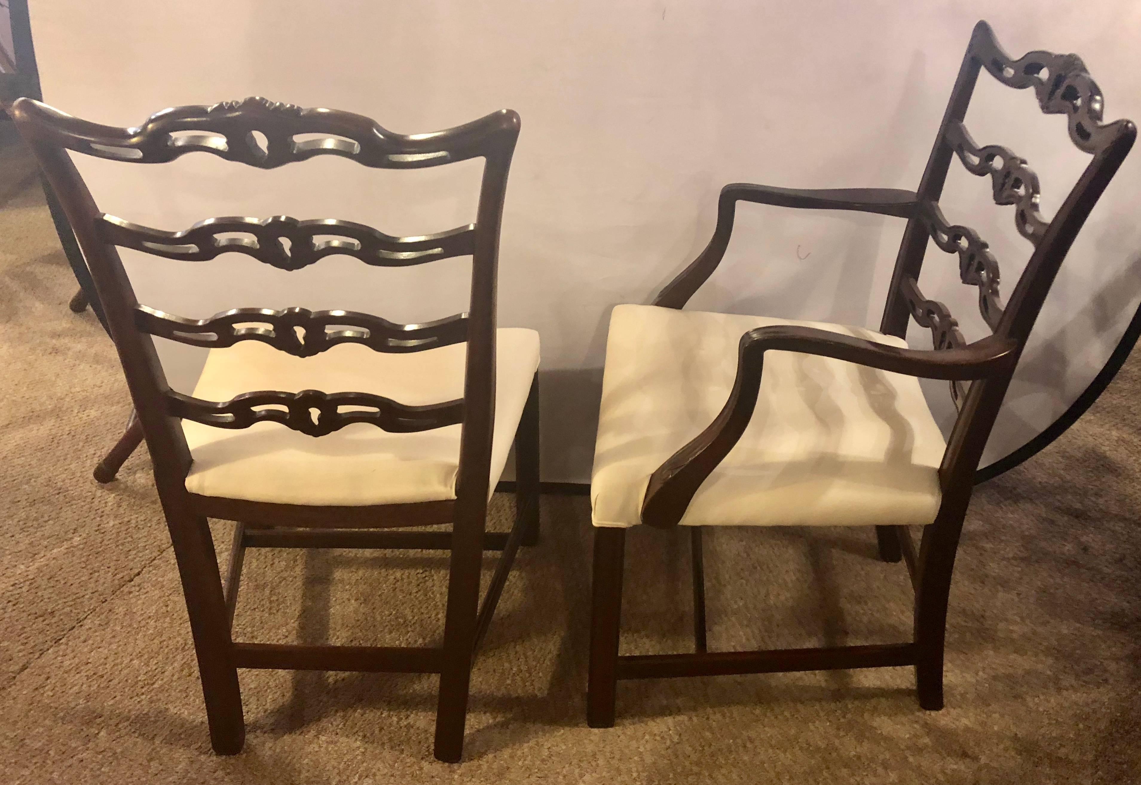 Set of ten ladder back Chippendale style dining chairs newly upholstered and polished. These fine early Chinese chippendale style dining chairs have ladder backs with shell carved motifs sitting on straight legs with undercarriage supports. Can