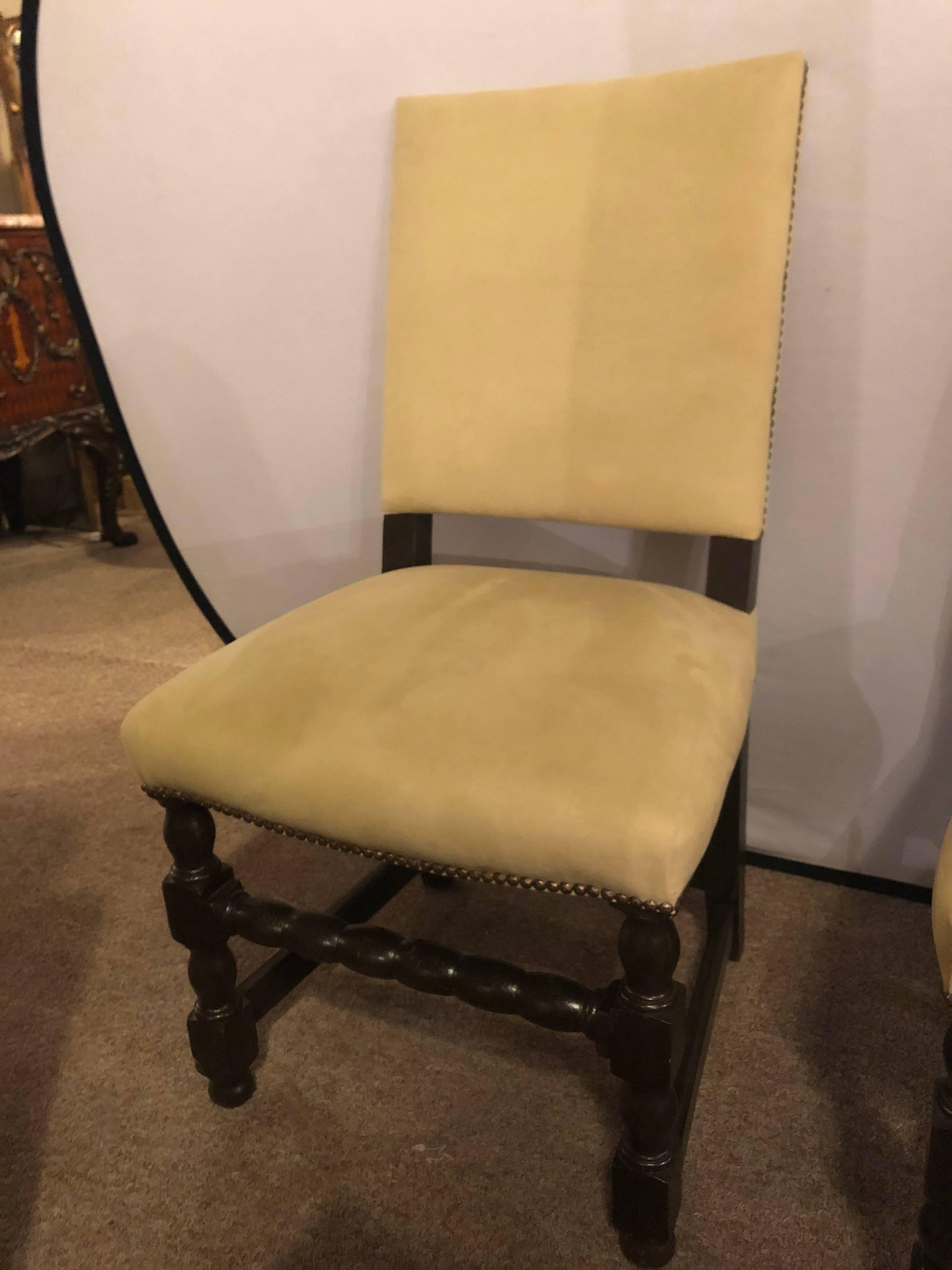 A set of ten English Tudor style dining or side chairs. Jacobean style. Can buy six, eight or all ten. The fine strong carved frames supported by a barley twist group of legs having covered seats and backs with tacked sides. In fine condition and