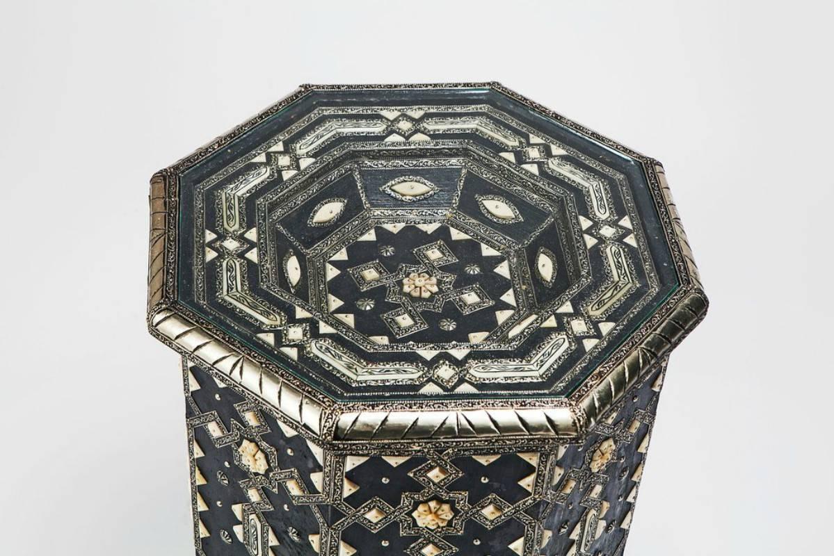 This luxurious wooden and silver-metal table is an exotic and sophisticated addition to any room. Featuring a dazzling geometric pattern, soothing color combinations and a beautifully realized Moorish component, this classic table possesses unique
