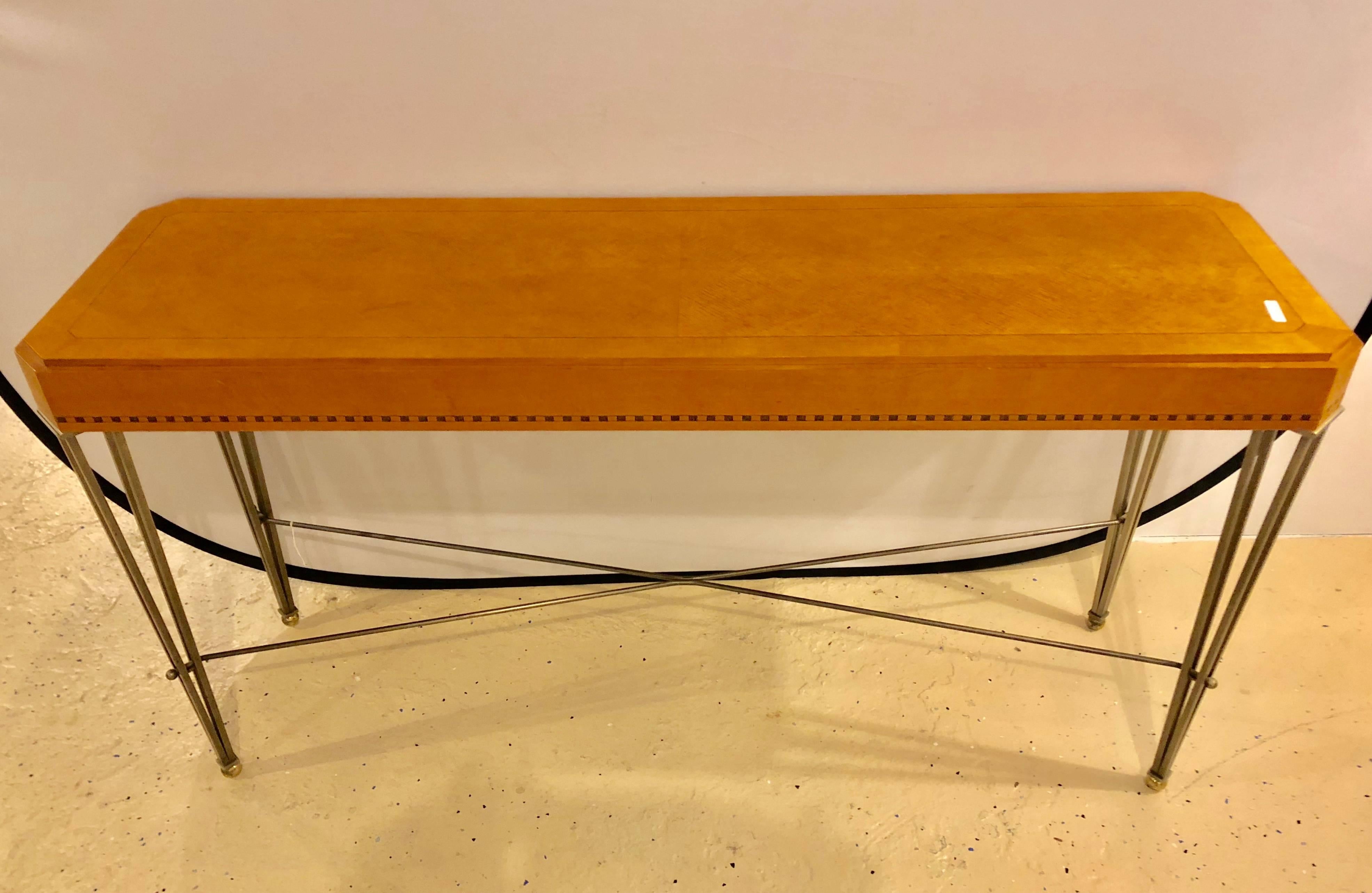 A fine Hollywood Regency style console or sofa table, American, late 20th century. A maple veneer console table, having chamfered corners and checkerboard detailing, on patinated metal legs with ball feet.