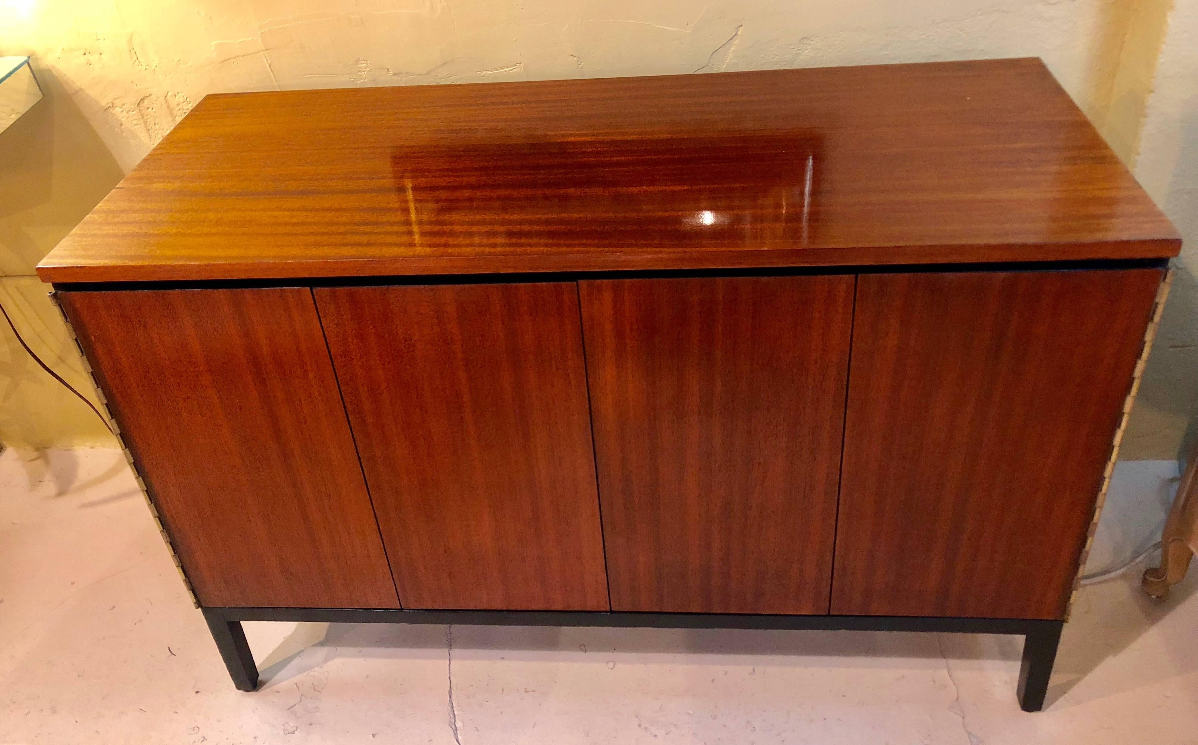 A fine custom quality pair of Mid-Century Modern Paul McCobb for Calvin chests or nightstands. Fine custom piano hinged doors leading to exceptional fitted and ebonized interiors. Each having multiple drawers. One with full drawers and one with side