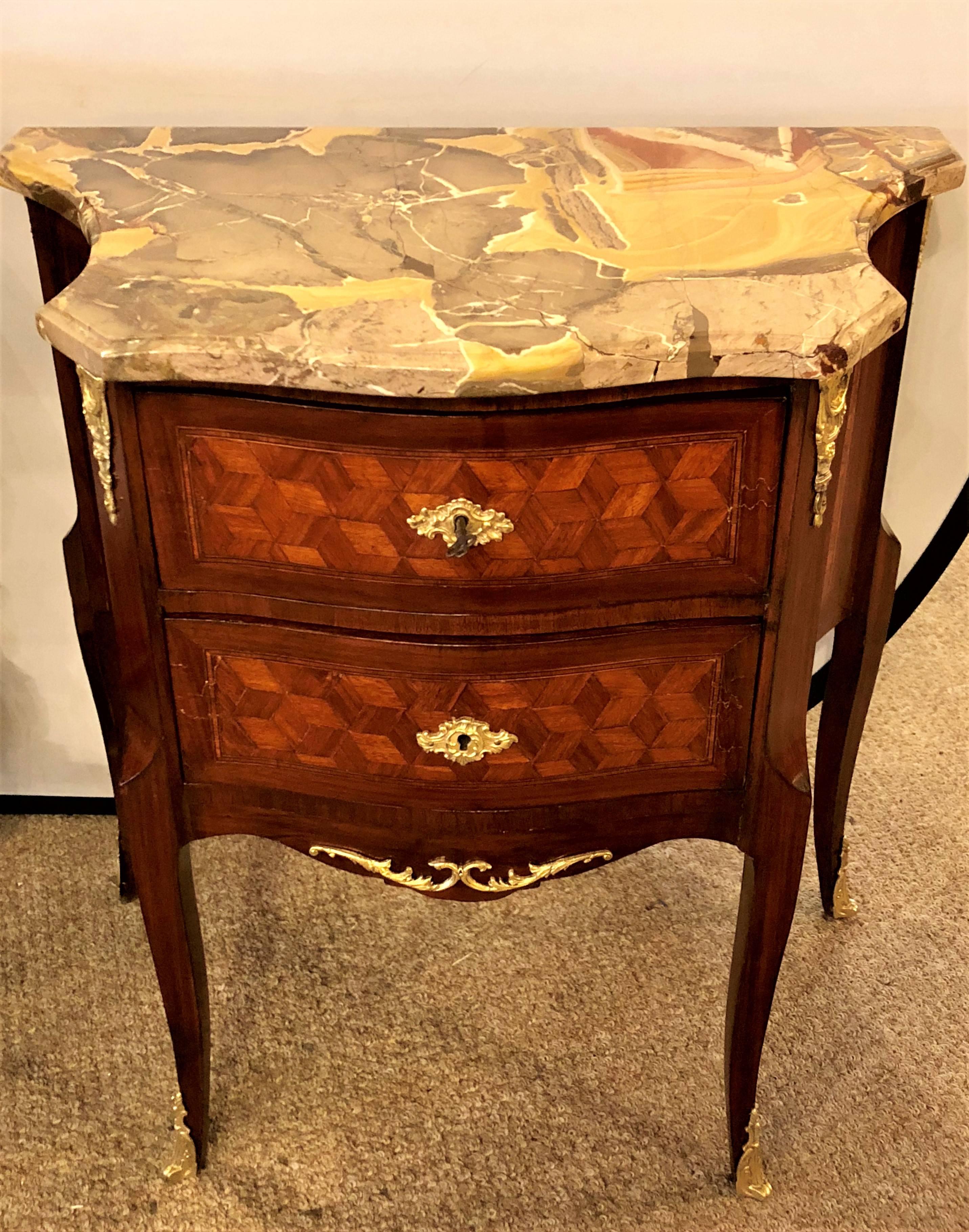 A pair of French marble top two drawers bronze-mounted tables or nightstands. Each Louis XV style stand having two parquet inlaid drawers and marble tops in a kidney shaped form with inverted sides. Both have been professionally hand rubbed French