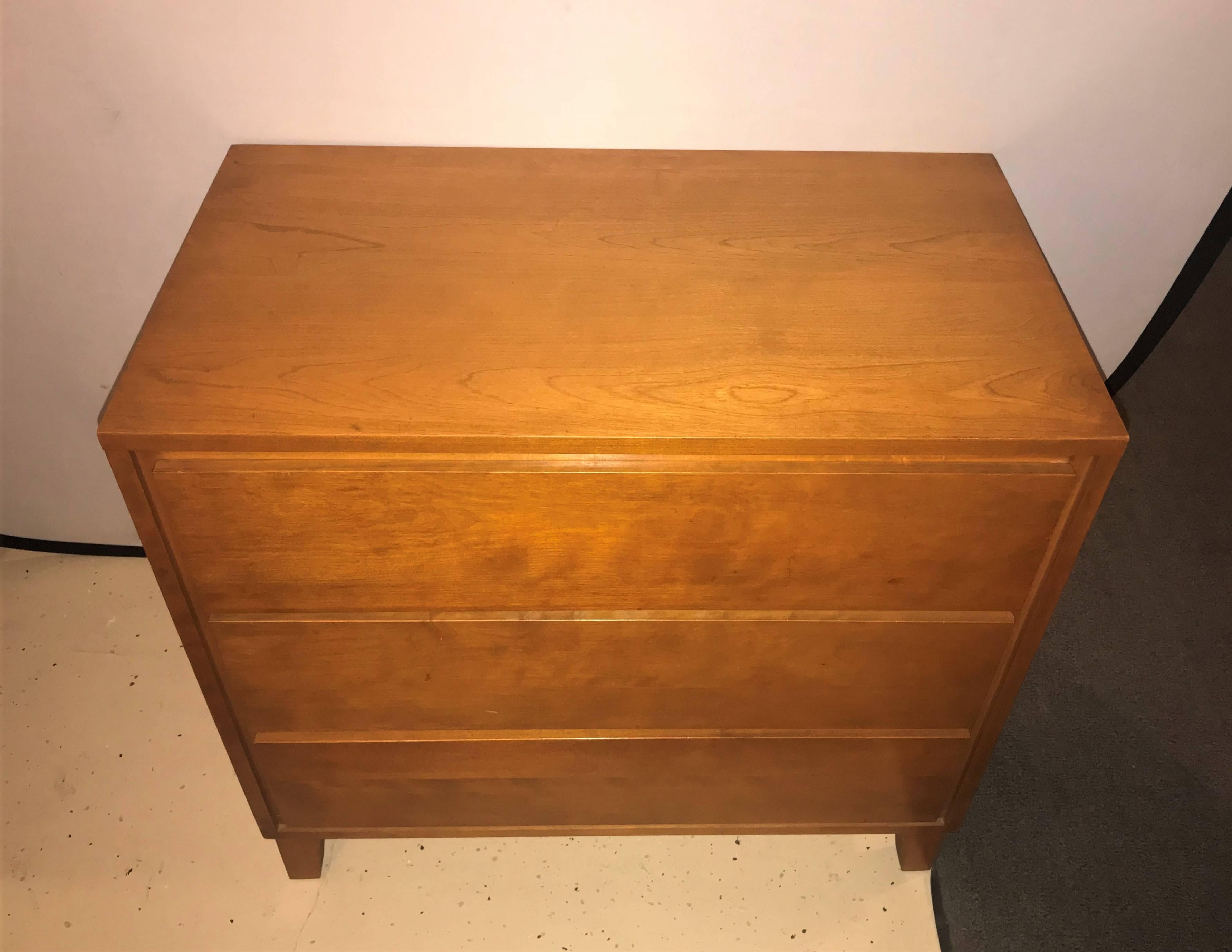 A pair of custom Mid-Century Modern chests / commodes or night tables by Conant Ball Makers. The case having three drawers in the Mid-Century Modern design.