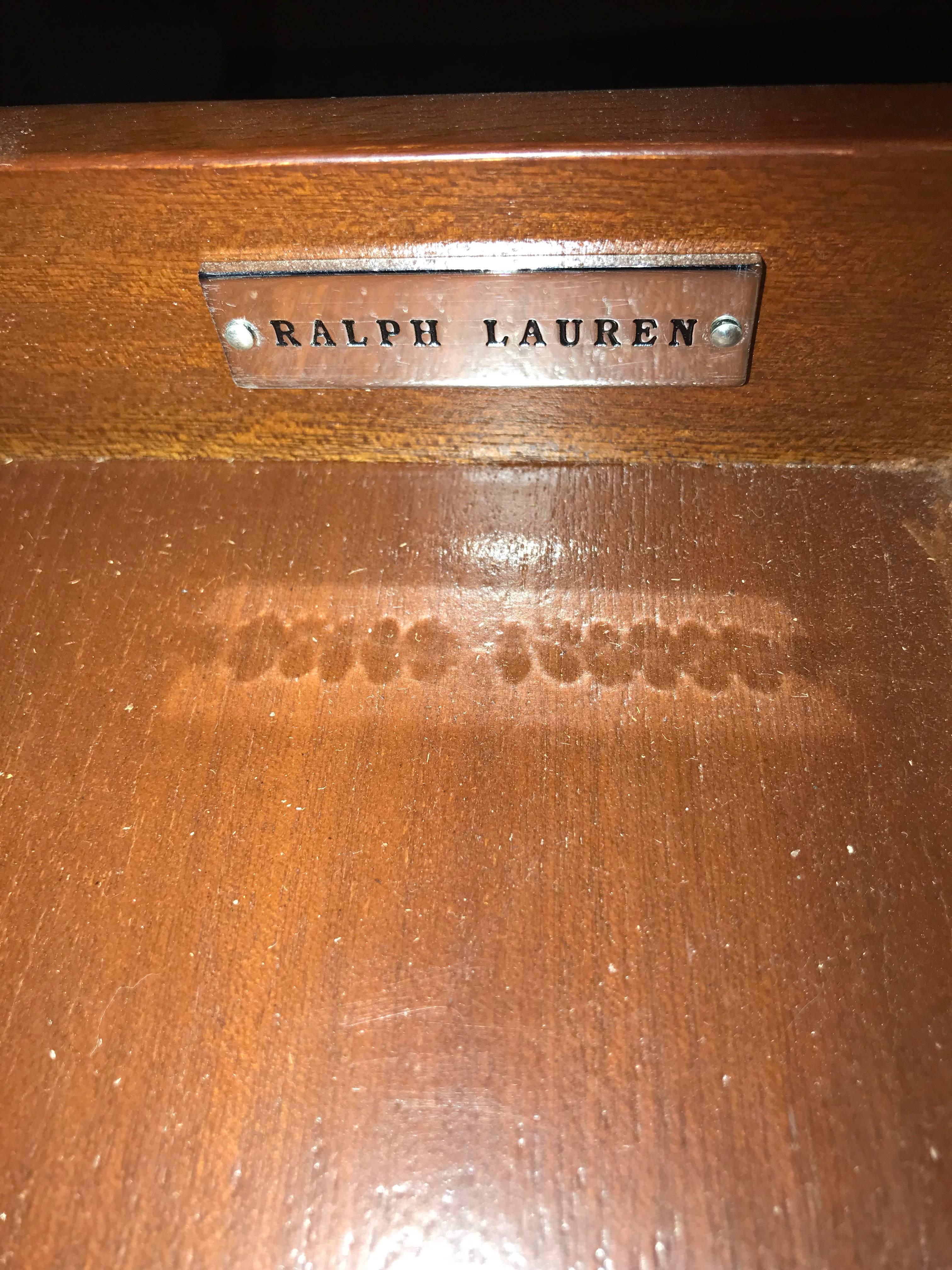 Bronze-mounted flame mahogany card table by Ralph Lauren with a drawer. Having a flip open top that displays a checker or chess board with a single drawer underneath. The whole resting on Louis XVI style legs with bronze castings and sabots. This