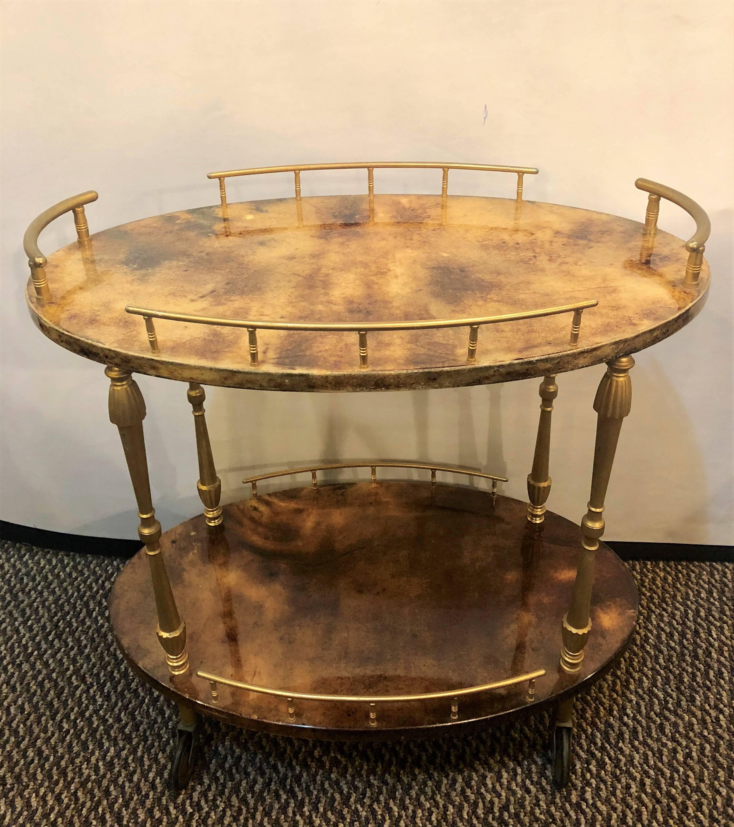 This sweet Aldo Tura diminutive modern goatskin trolley or serving wagon is certain to grab attention. Having a galleried brass top and bottom shelf this wonderfully designed cart by this highly sought after designer is certain to shock all when it