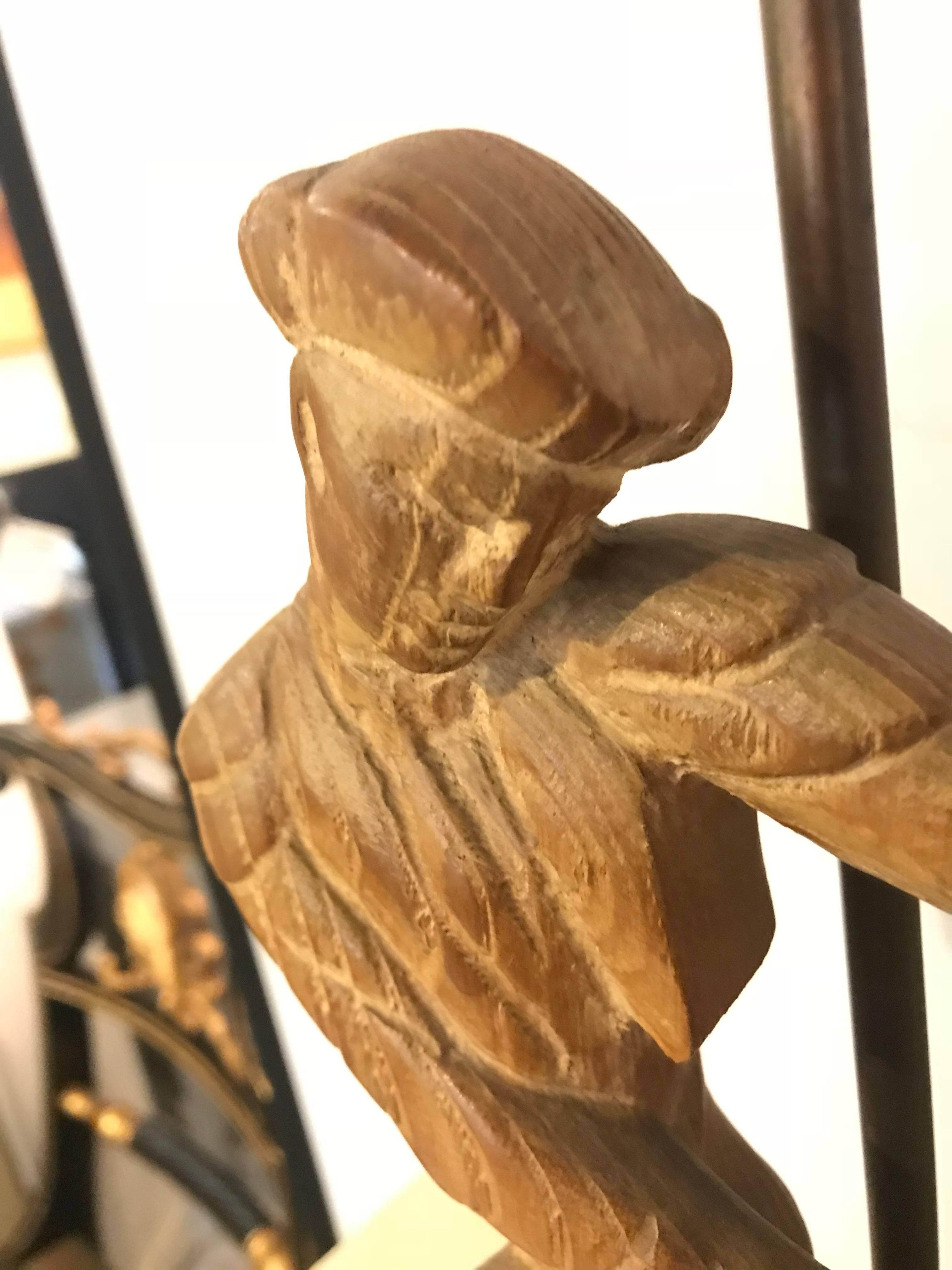 A pair of Art Deco style pickled finish wood carved table lamps depicting a man and a woman with carved wooden finials.