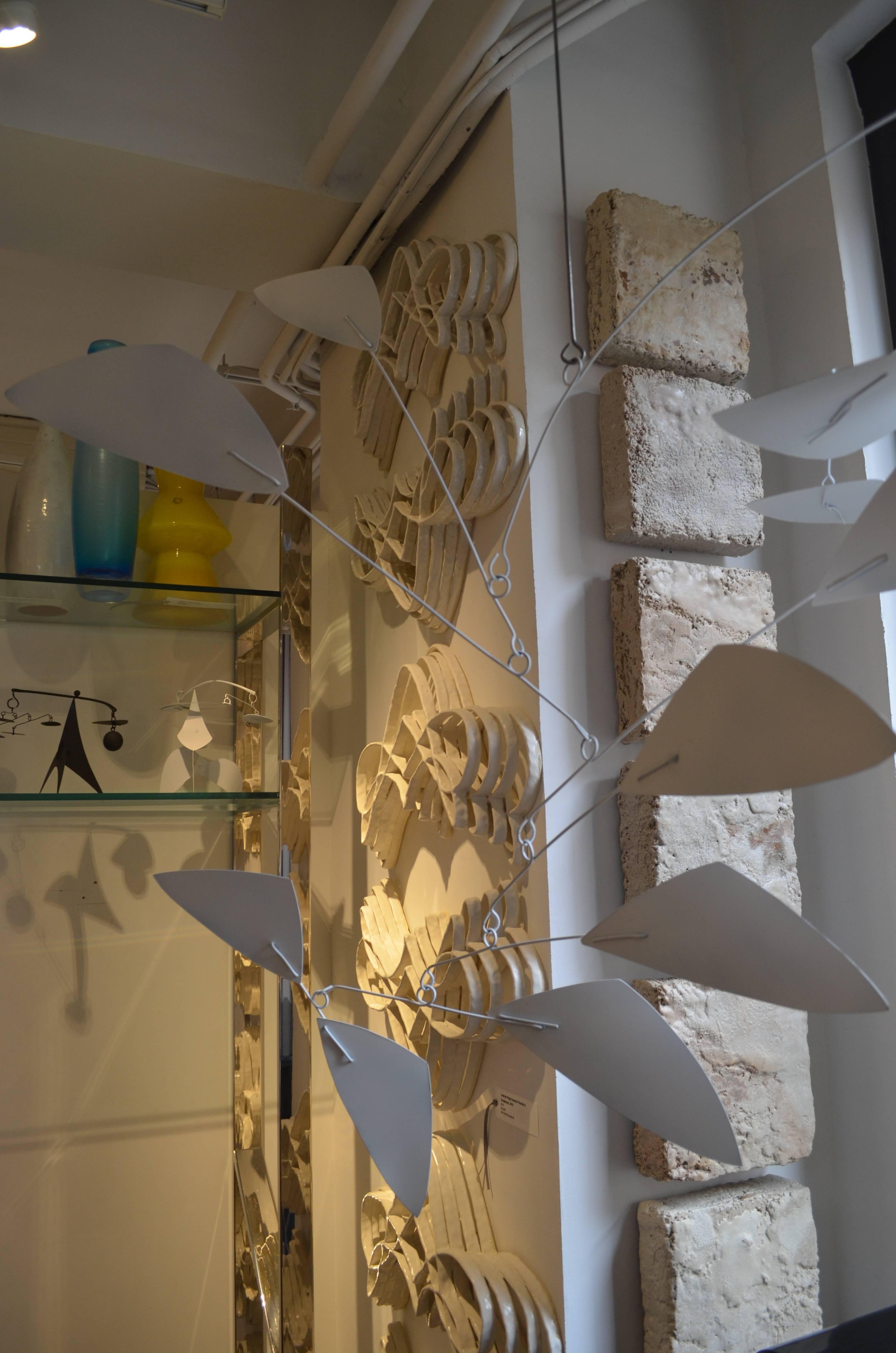 Contemporary New York artist/sculptor Jim Hunter's modern hanging white painted metal mobile is a Kinetic sculpture. Different sizes, colors, shapes and custom work available, please contact the dealer for more details. The body of the sculpture is